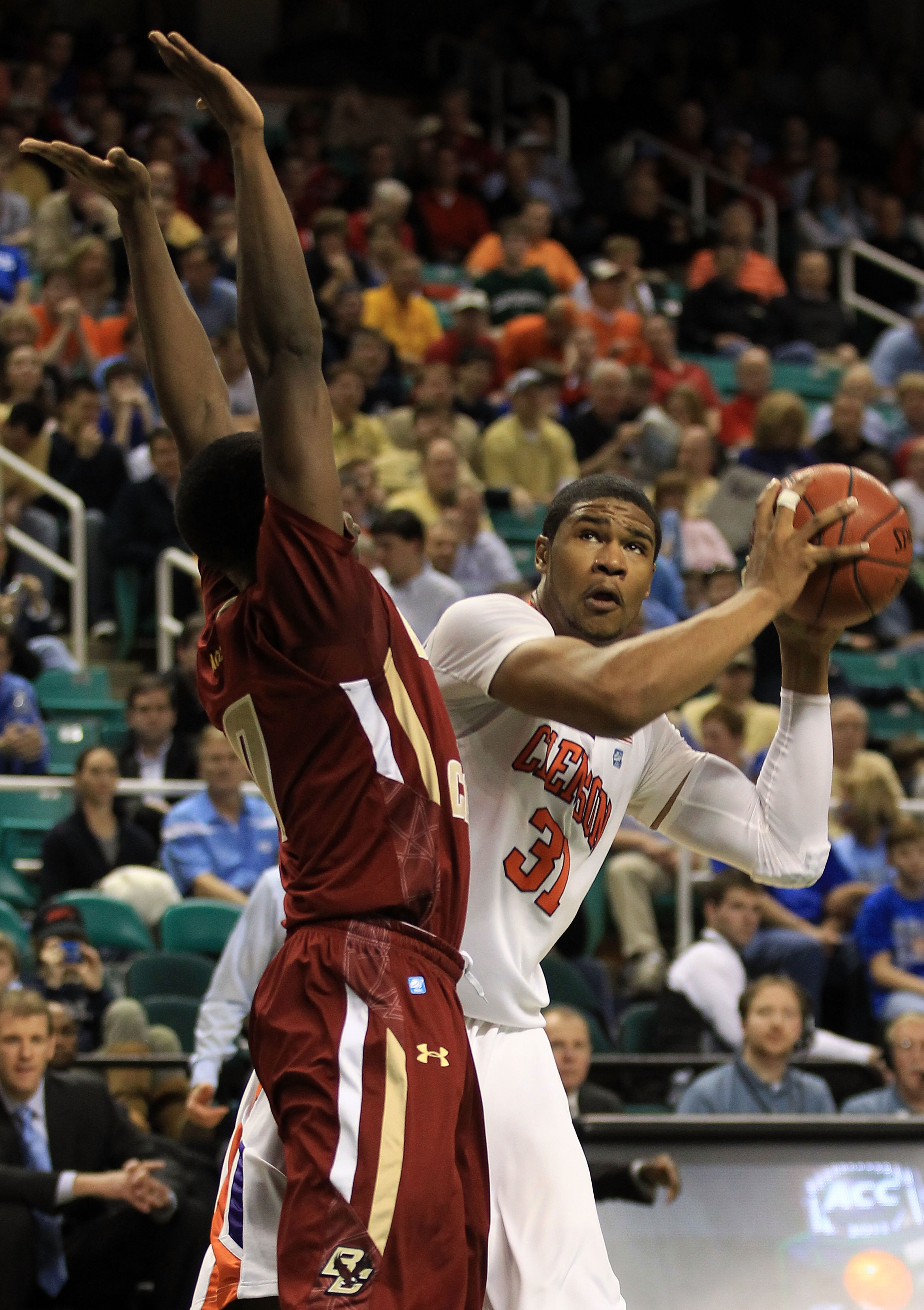 GREENSBORO, NC - MARCH 11:  Devin Booker #31 of the Clemson Tigers looks to shoot against Reggie Jackson #0 of the Boston College Eagles during the first half in the quarterfinals of the 2011 ACC men's basketball tournament at the Greensboro Coliseum on M