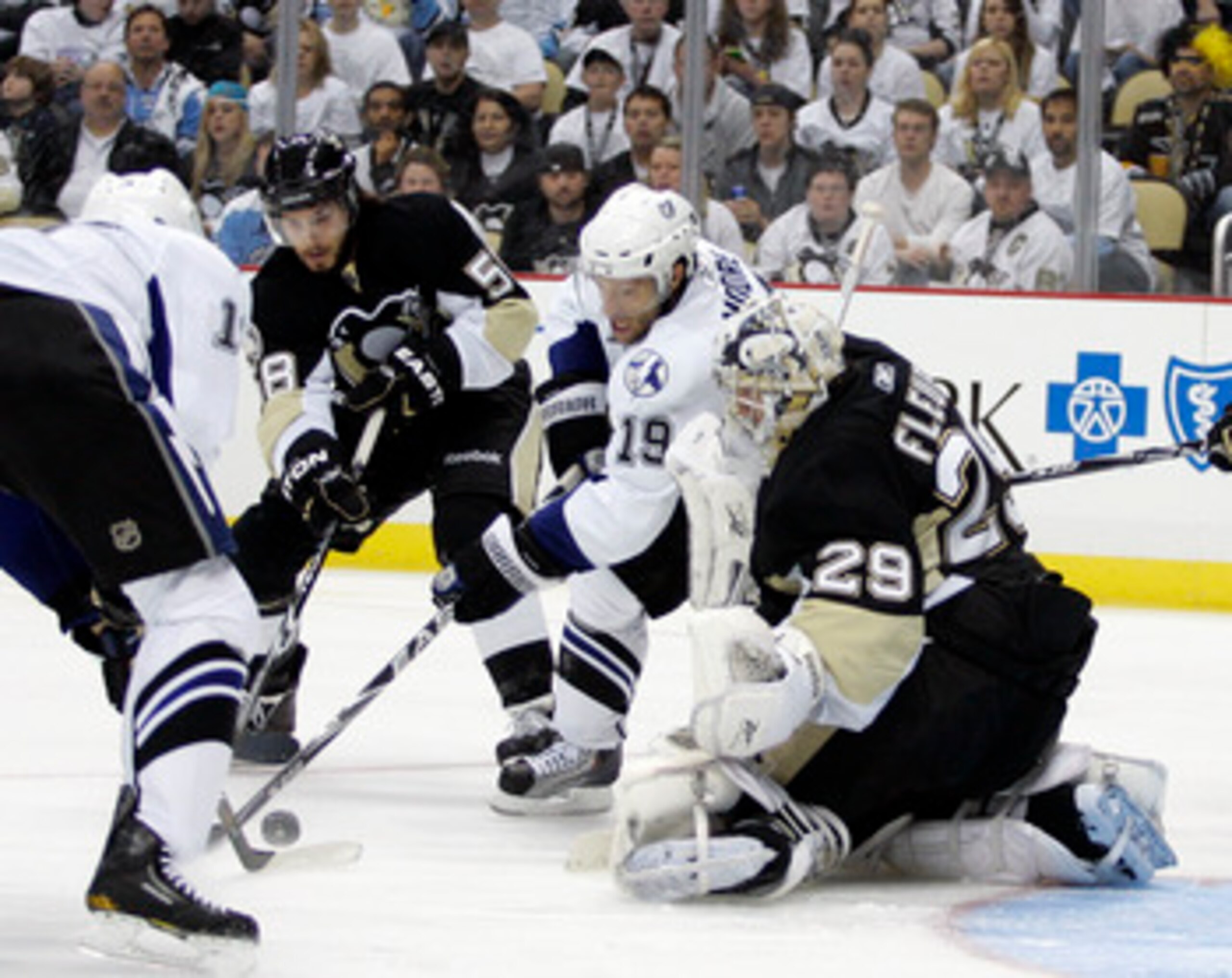 PITTSBURGH, PA - APRIL 23:  Dominic Moore #19 of the Tampa Bay Lightning battles for the puck with Kris Letang #58 as Marc-Andre Fleury #29 of the Pittsburgh Penguins protects the net in Game Five of the Eastern Conference Quarterfinals during the 2011 NH