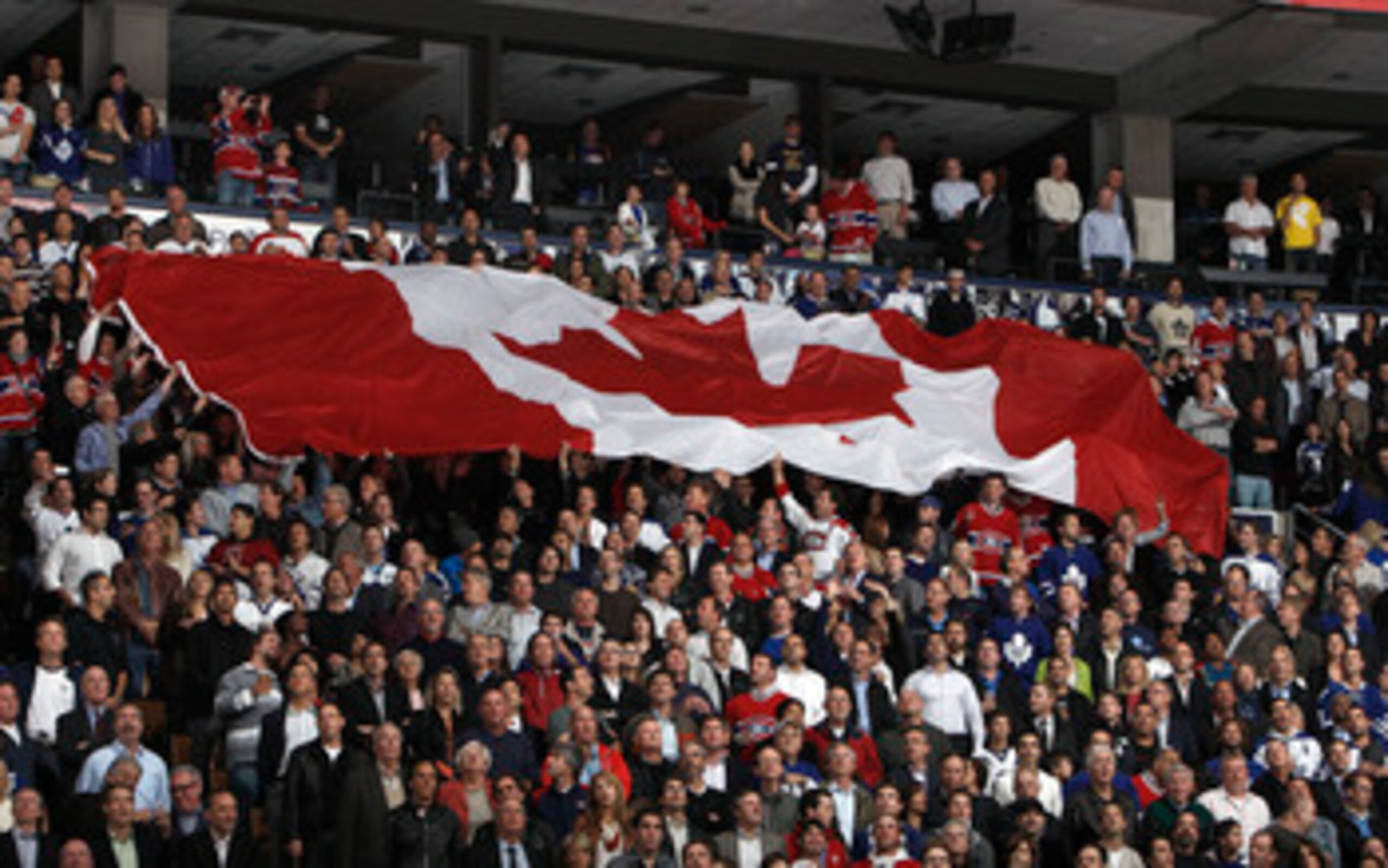 TORONTO, CANADA - OCTOBER 07: A giant Canadian flag is passed around during an opening night pre-game ceremony before a regular season NHL game between the Toronto Maple Leafs and the Montreal Canadiens at the Air Canada Centre October 7, 2010 in Toronto TORONTO, CANADA - OCTOBER 07: A giant Canadian flag is passed around during an opening night pre-game ceremony before a regular season NHL game between the Toronto Maple Leafs and the Montreal Canadiens at the Air Canada Centre October 7, 2010 in Toronto