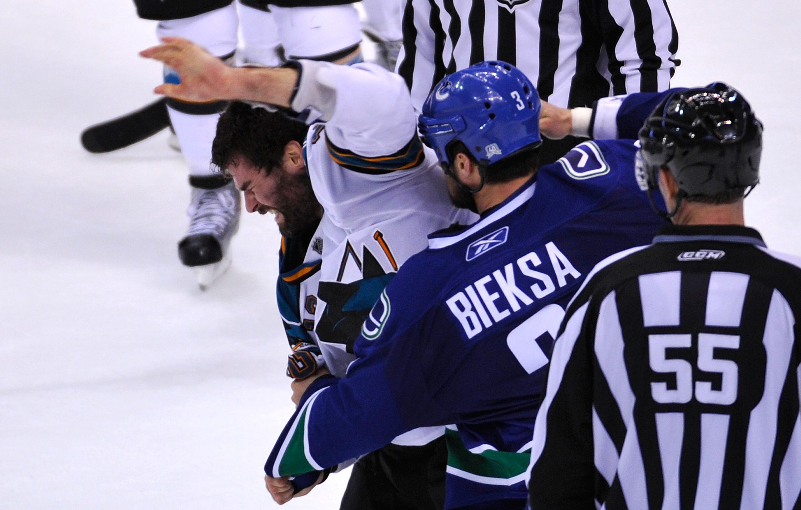VANCOUVER, CANADA - MAY 18:  Patrick Marleau #12 of the San Jose Sharks tries to defend himself during a fight as Kevin Bieksa #3 of the Vancouver Canucks prepares to throw a punch in the second period in Game Two of the Western Conference Finals during t