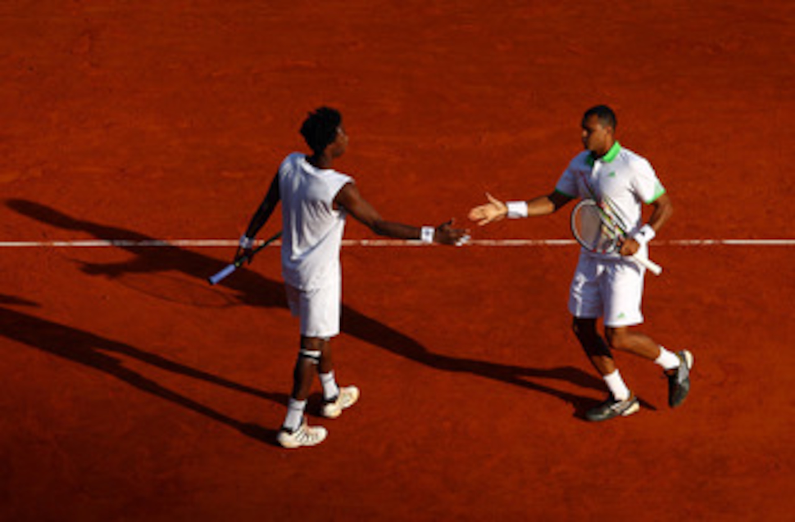 MONACO - APRIL 13:  Gael Monfils (L) of France with partner Jo-Wilfried Tsonga of France in their doubles match against Lukas Dlouhy of Czech Republic and Janko Tipsarevic of Serbia during Day Four of the ATP Masters Series Tennis at the Monte Carlo Count