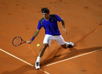 ROME, ITALY - MAY 11:  Roger Federer of Switzerland stretches for the ball during his second round match against Jo-Wilfried Tsonga of France during day four of the Internazionali BNL d'Italia at the Foro Italico Tennis Centreon May 11, 2011 in Rome, Ital