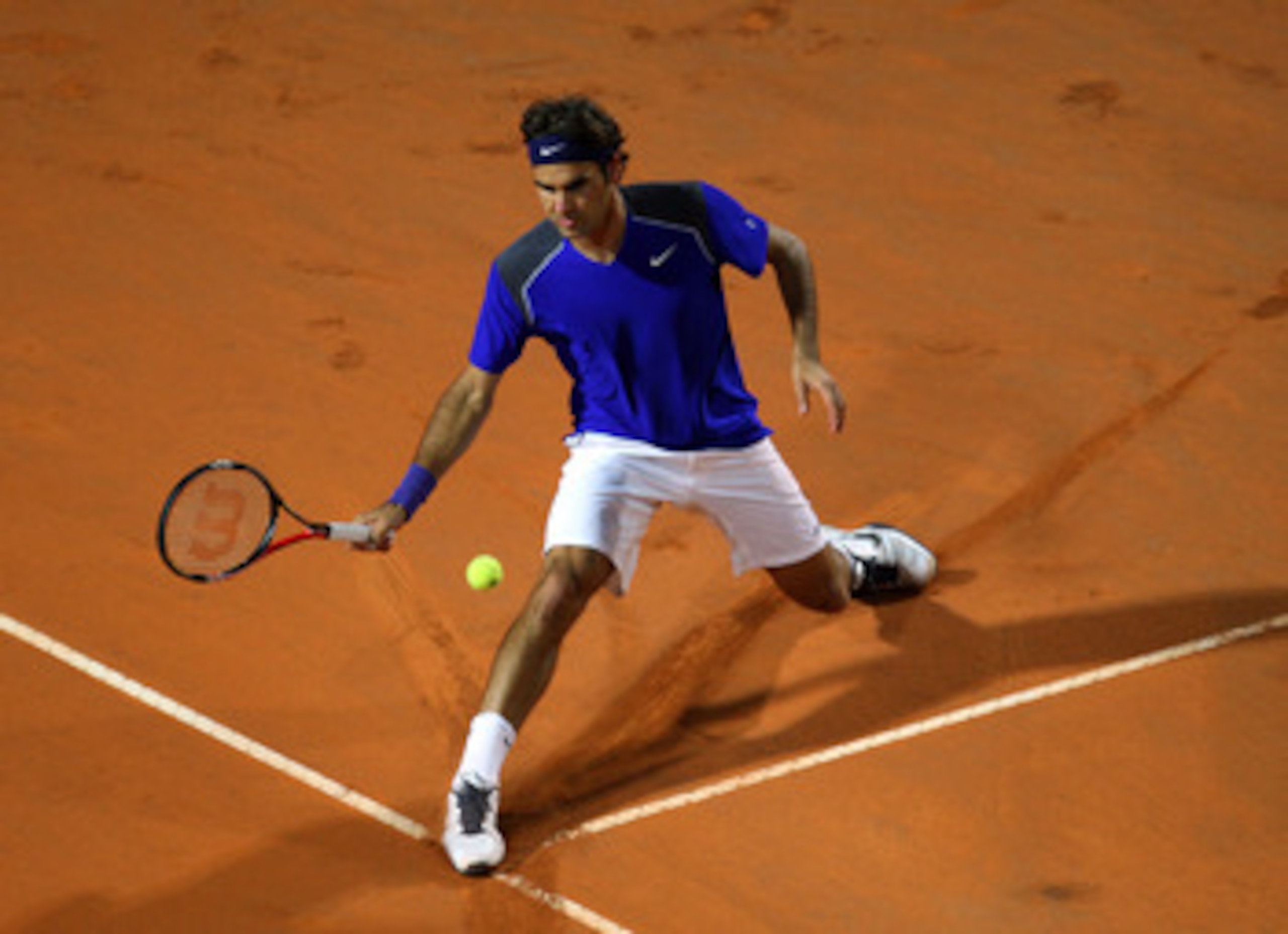 ROME, ITALY - MAY 11:  Roger Federer of Switzerland stretches for the ball during his second round match against Jo-Wilfried Tsonga of France during day four of the Internazionali BNL d'Italia at the Foro Italico Tennis Centreon May 11, 2011 in Rome, Ital