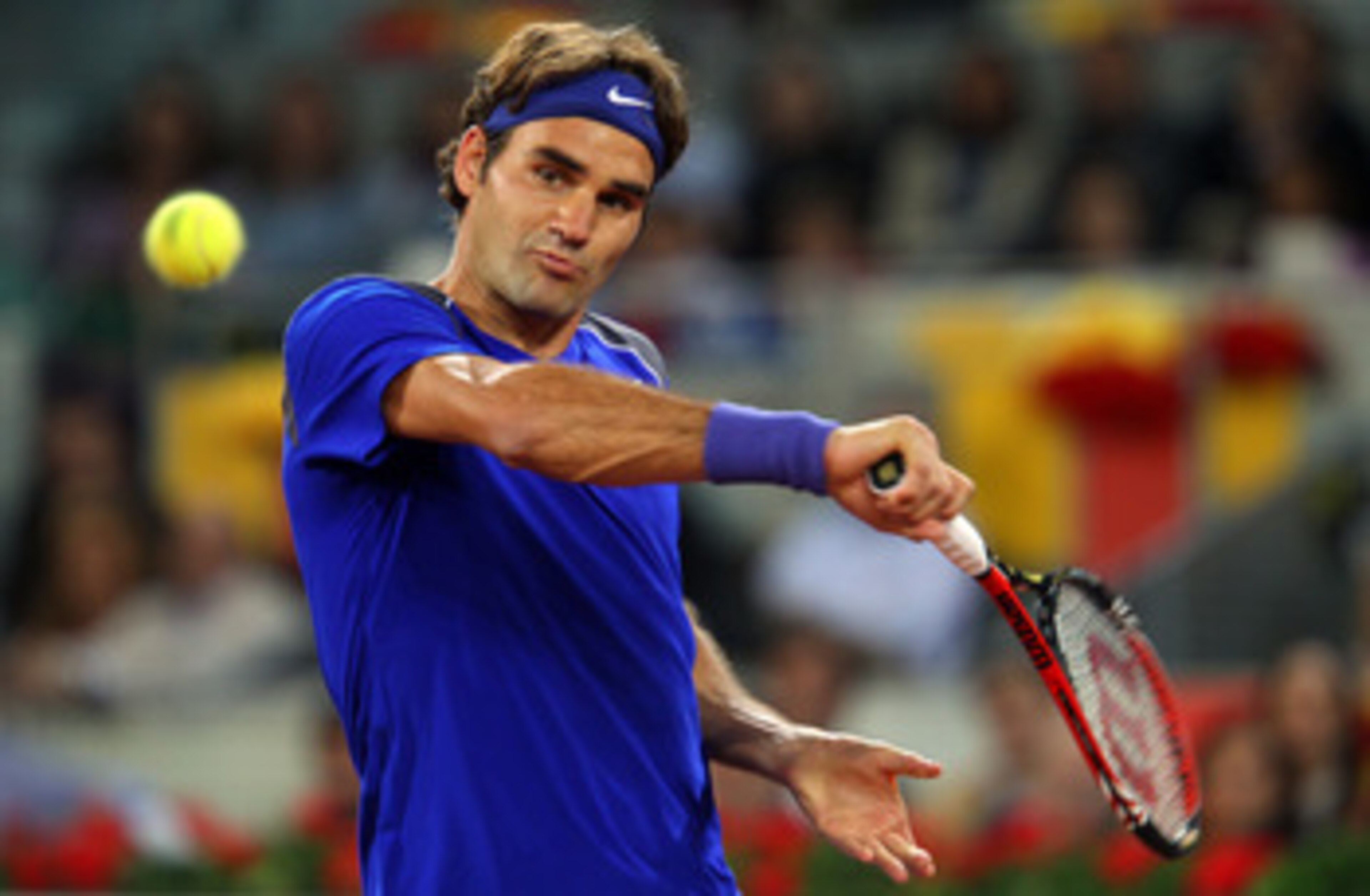 MADRID, SPAIN - MAY 07:  Roger Federer of Switzerland plays a backhand in his match against Rafael Nadal of Spain during day eight of the Mutua Madrilena Madrid Open Tennis on May 7, 2011 in Madrid, Spain.  (Photo by Julian Finney/Getty Images)