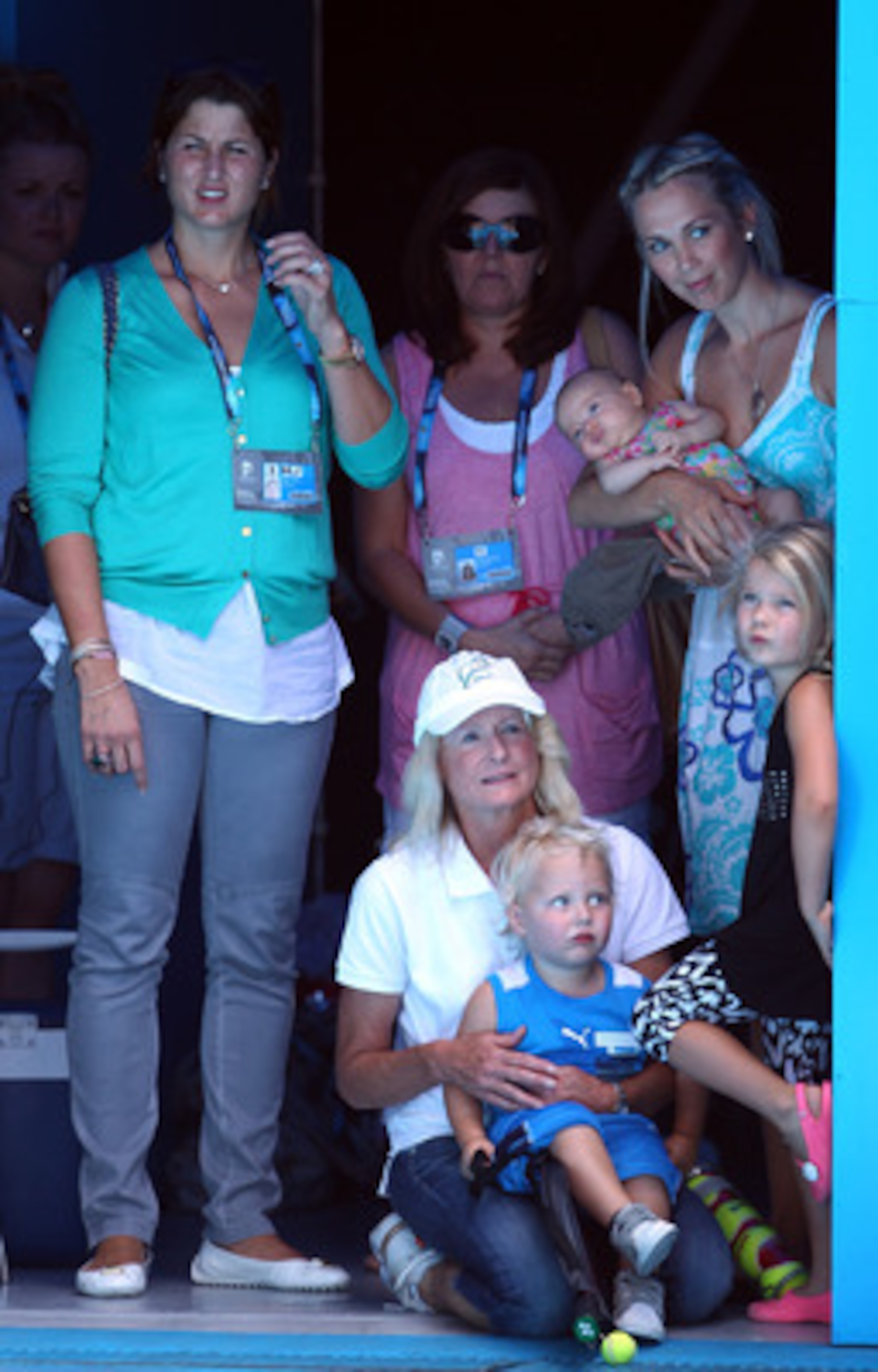 MELBOURNE, AUSTRALIA - JANUARY 16:  Mirka Federer, Cherilyn Hewitt with Cruz, Bec Cartwright and Mia enjoy the tennis during the 'Rally For Relief' charity exhibition match ahead of the 2011 Australian Open at Melbourne Park on January 16, 2011 in Melbour