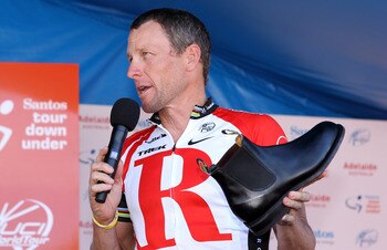 ADELAIDE, AUSTRALIA - JANUARY 23:  Lance Armstrong of the USA and Team Radio Shack holds a RM Williams shoe that is made locally in South Australia and was a presented to him as a gift by the Premier of South Australia, Mike Rann, after Stage Six of the 2