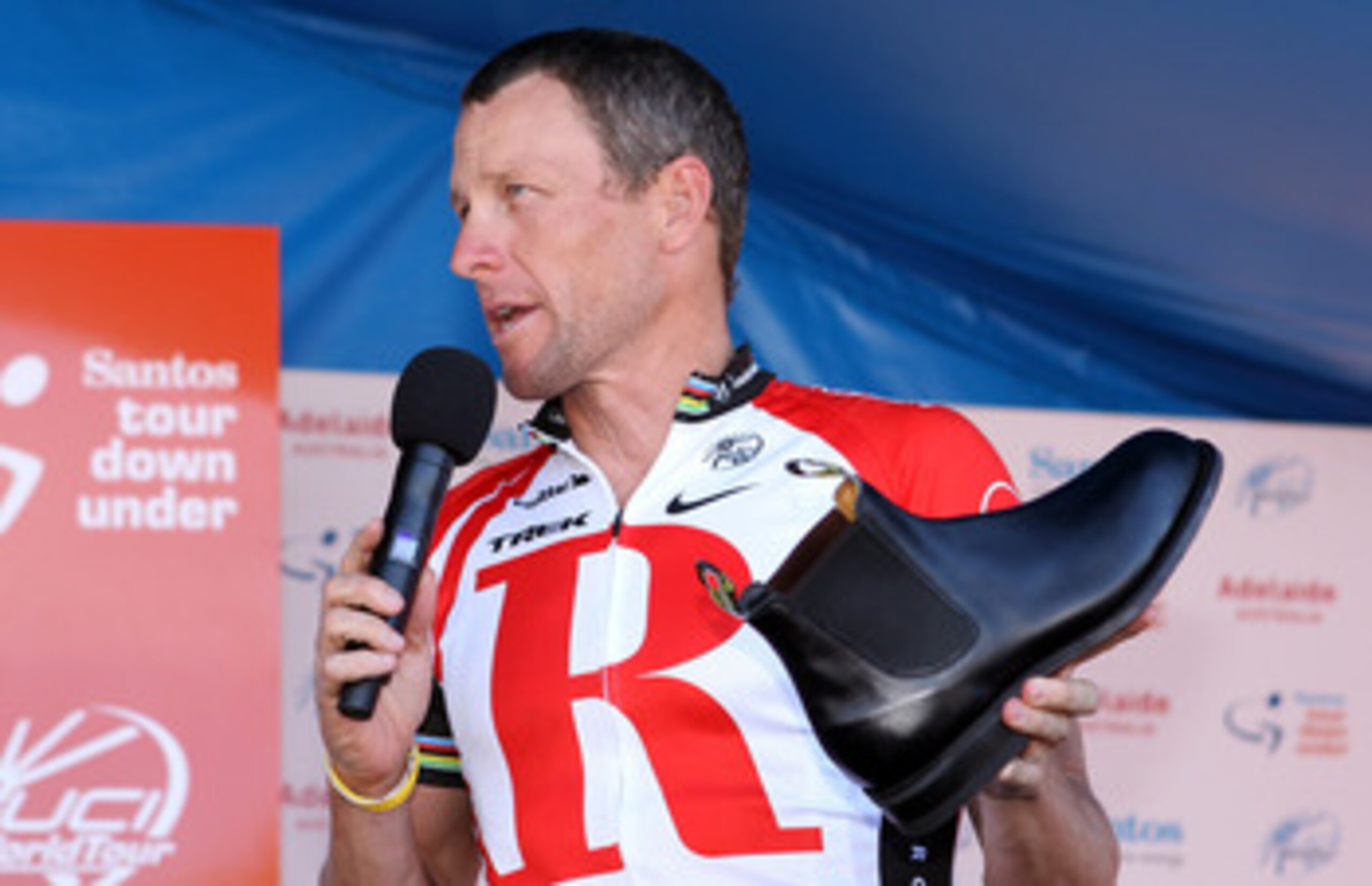 ADELAIDE, AUSTRALIA - JANUARY 23:  Lance Armstrong of the USA and Team Radio Shack holds a RM Williams shoe that is made locally in South Australia and was a presented to him as a gift by the Premier of South Australia, Mike Rann, after Stage Six of the 2