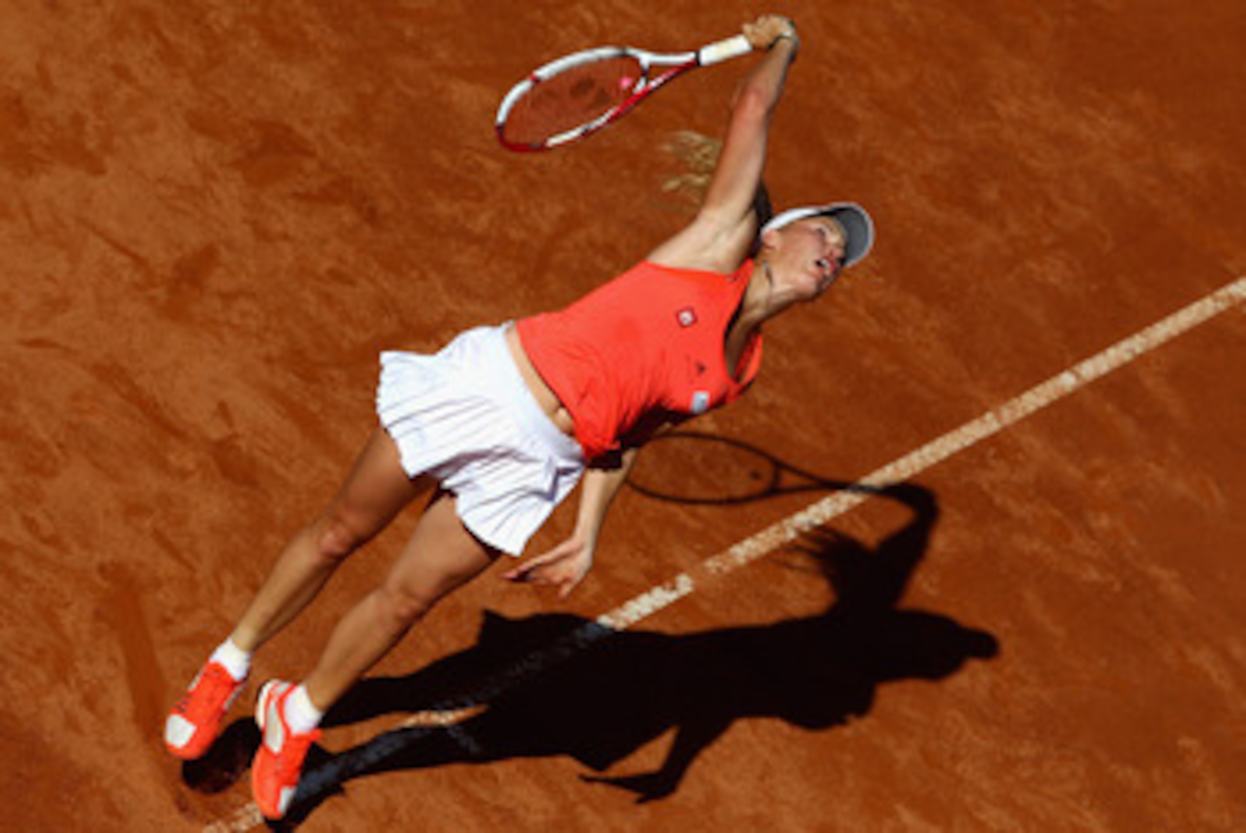 ROME, ITALY - MAY 14: Caroline Wozniacki of Denmark serves during her semi final match against Maria Sharapova of Russia during day seven of the Internazoinali BNL D'Italia at the Foro Italico Tennis Centre on May 14, 2011 in Rome, Italy. (Photo by Cli ROME, ITALY - MAY 14: Caroline Wozniacki of Denmark serves during her semi final match against Maria Sharapova of Russia during day seven of the Internazoinali BNL D'Italia at the Foro Italico Tennis Centre on May 14, 2011 in Rome, Italy. (Photo by Cli