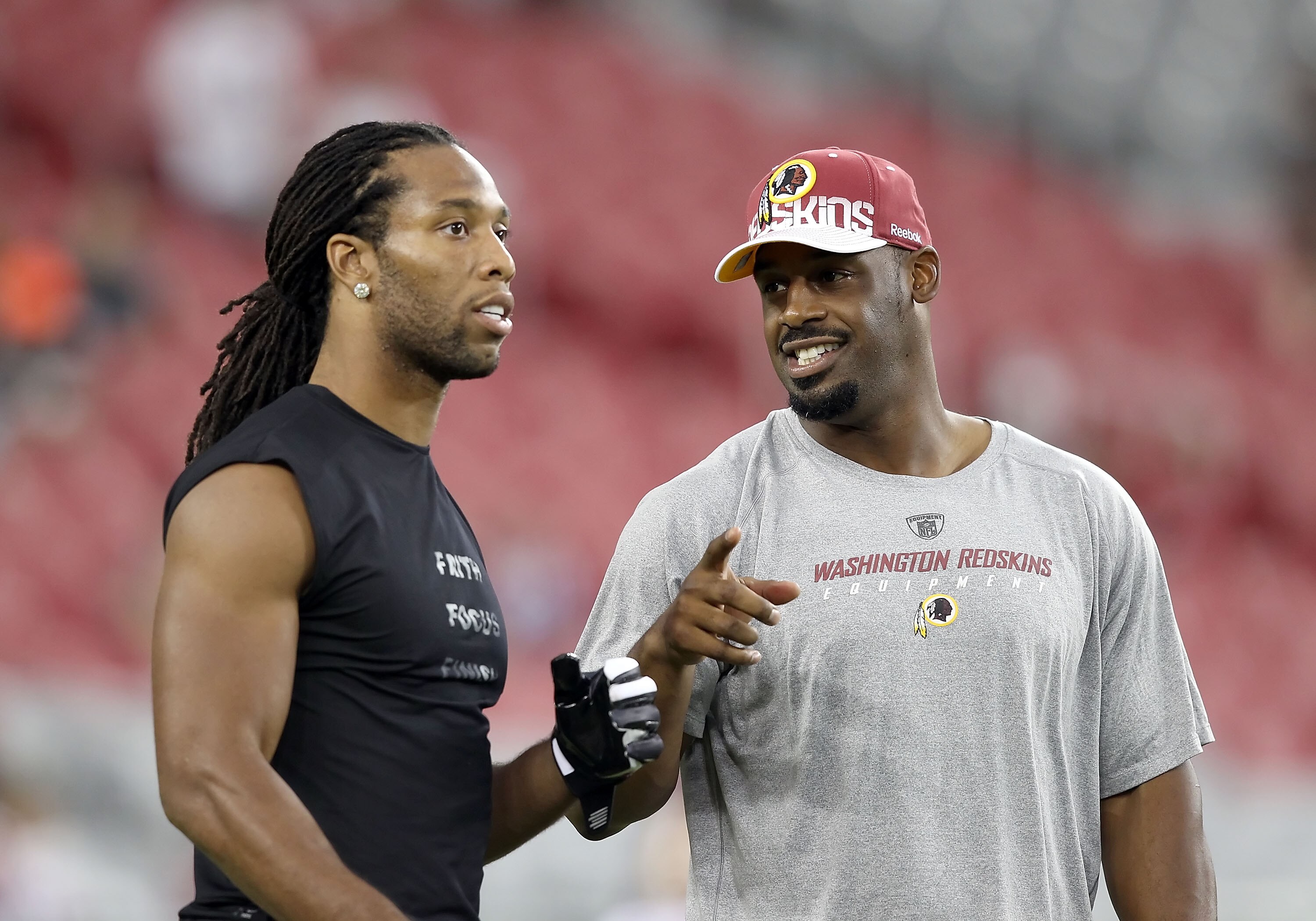 GLENDALE, AZ - SEPTEMBER 02:  Quarterback Donovan McNabb #5 of the Washington Redskins talks with Larry Fitzgerald #11 of the Arizona Cardinals before the preseason NFL game at the University of Phoenix Stadium on September 2, 2010 in Glendale, Arizona. T
