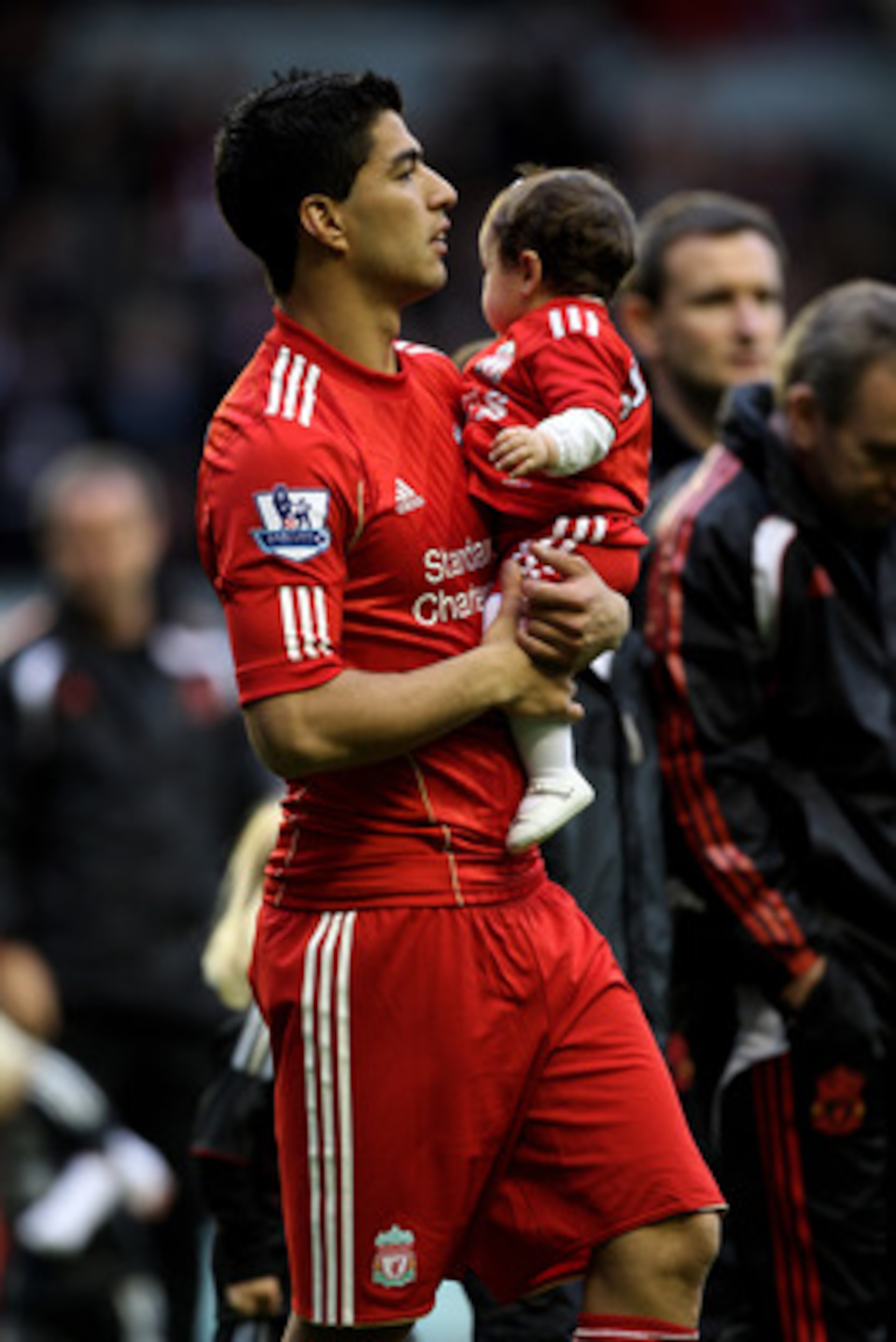 LIVERPOOL, ENGLAND - MAY 15:  Luis Suarez of Liverpool parades around the pitch following the final home game of the season after the Barclays Premier League match between Liverpool and Tottenham Hotspur at Anfield on May 15, 2011 in Liverpool, England.