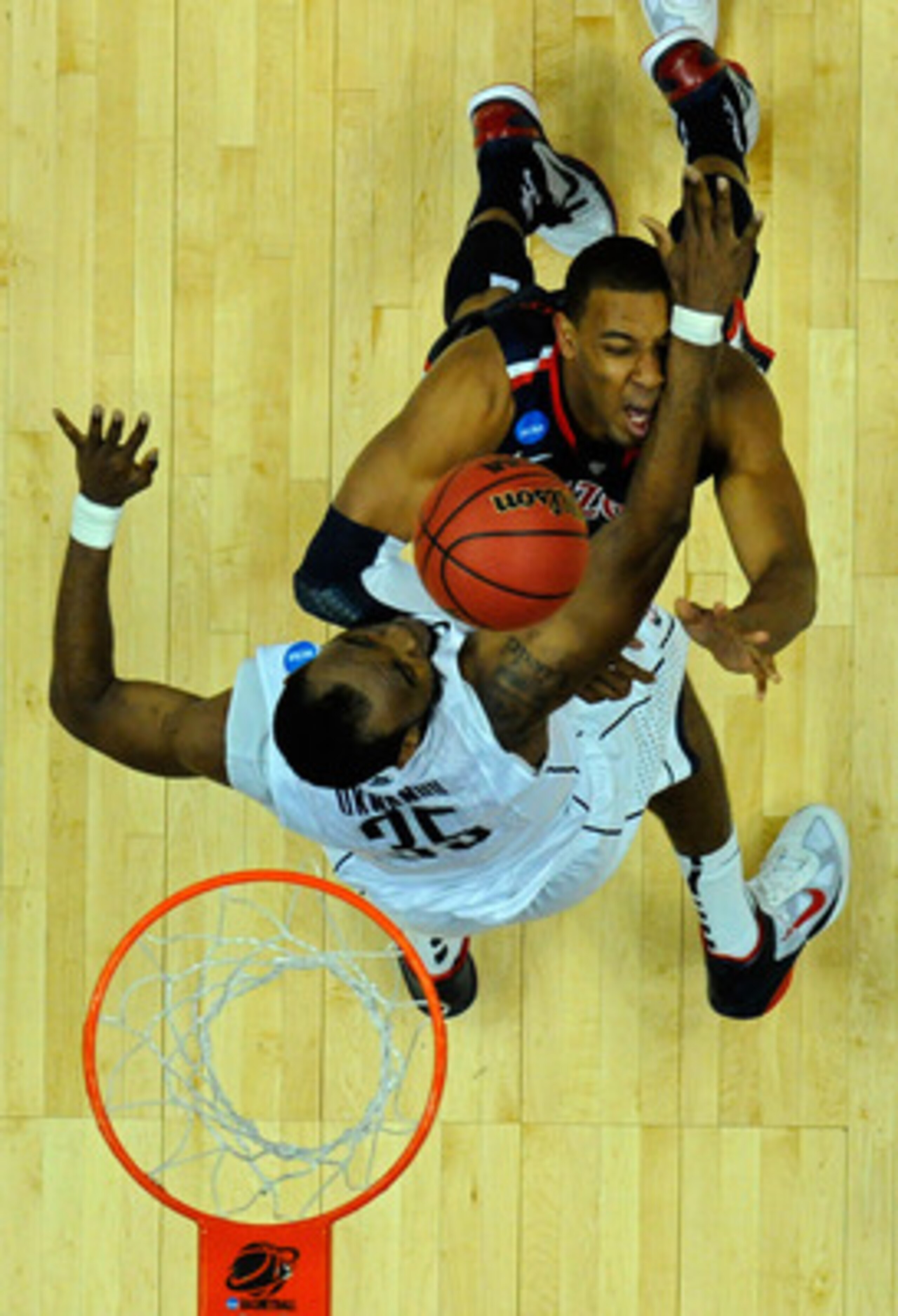 ANAHEIM, CA - MARCH 26:  Derrick Williams #23 of the Arizona Wildcats draws contact against Charles Okwandu #35 of the Connecticut Huskies during the west regional final of the 2011 NCAA men's basketball tournament at the Honda Center on March 26, 2011 in