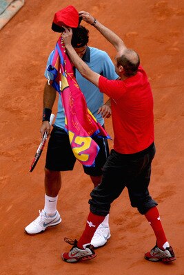 PARIS - JUNE 07:  An intruder on the court interferes with Roger Federer of Switzerland during the Men's Singles Final match Robin Soderling of Sweden and Roger Federer of Switzerland on day fifteen of the French Open at Roland Garros on June 7, 2009 in P