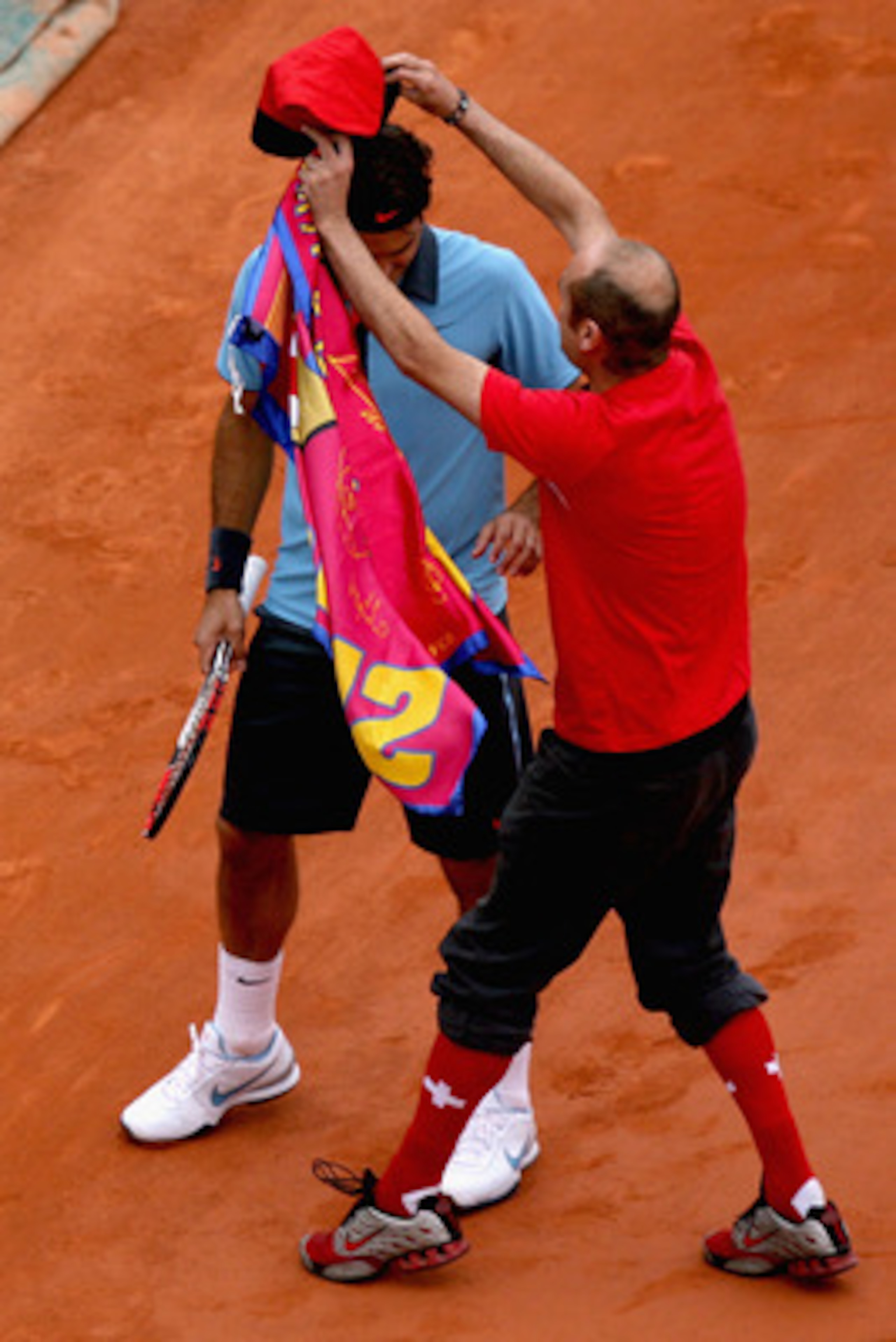 PARIS - JUNE 07:  An intruder on the court interferes with Roger Federer of Switzerland during the Men's Singles Final match Robin Soderling of Sweden and Roger Federer of Switzerland on day fifteen of the French Open at Roland Garros on June 7, 2009 in P