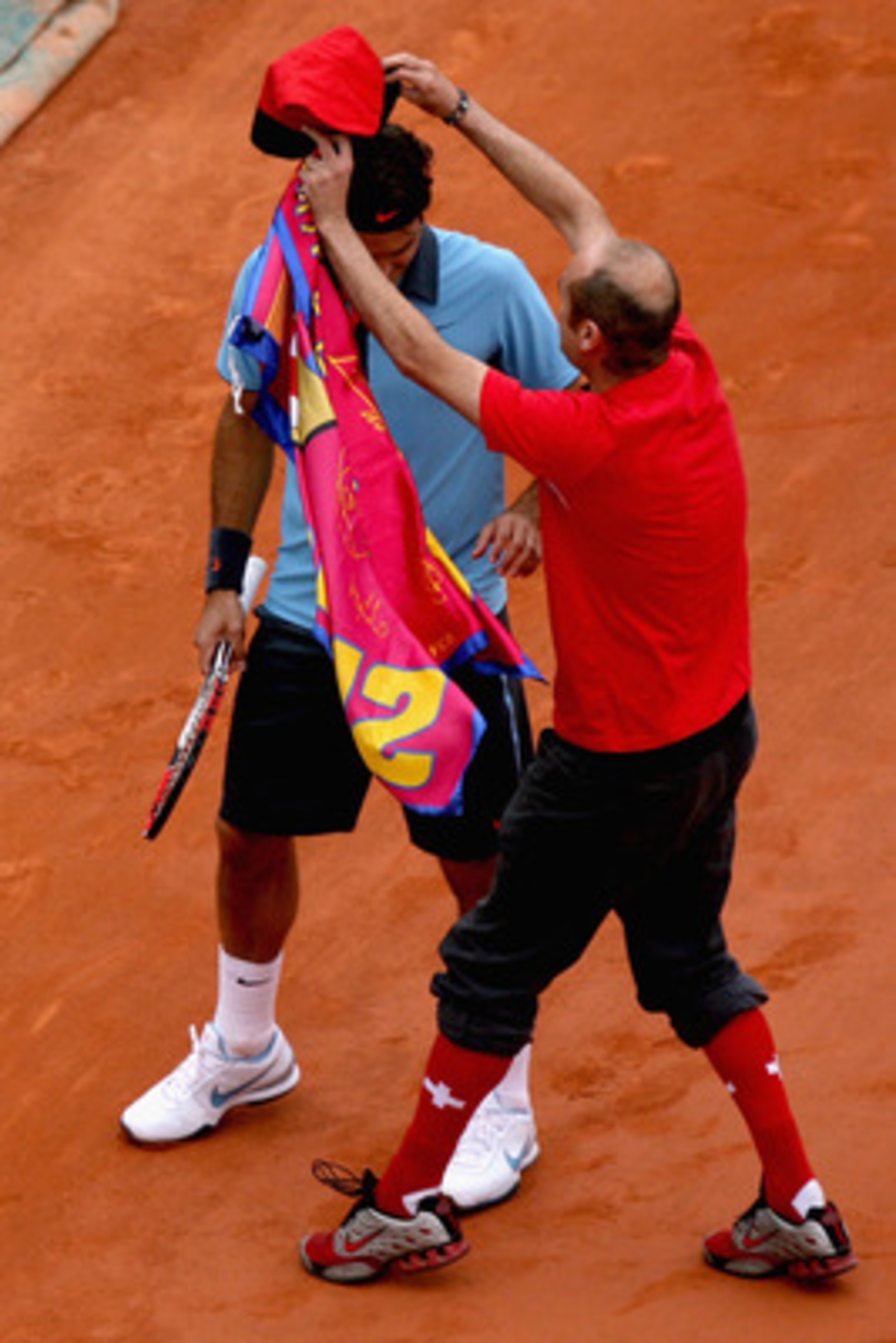 PARIS - JUNE 07:  An intruder on the court interferes with Roger Federer of Switzerland during the Men's Singles Final match Robin Soderling of Sweden and Roger Federer of Switzerland on day fifteen of the French Open at Roland Garros on June 7, 2009 in P