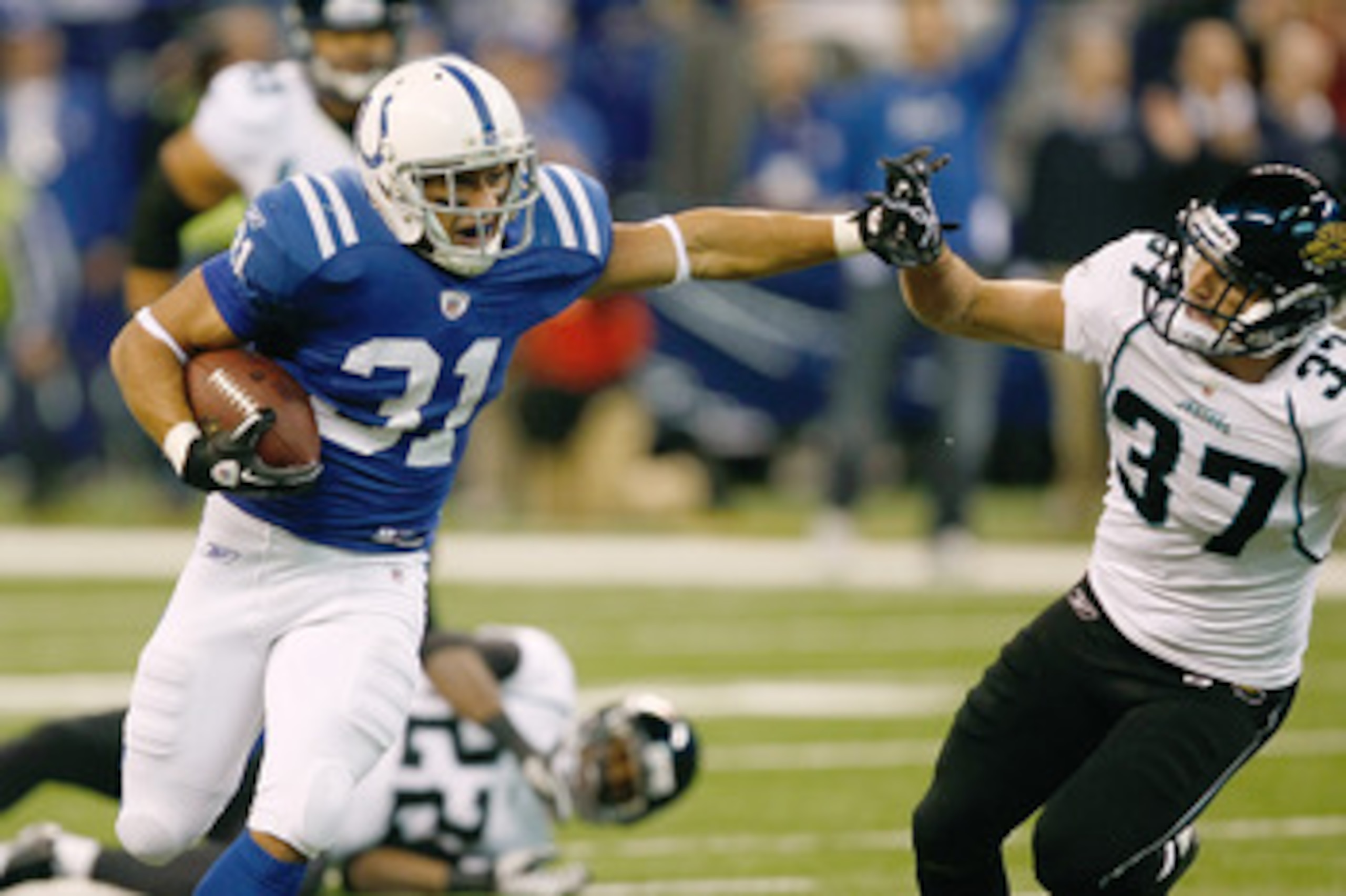 INDIANAPOLIS, IN - DECEMBER 19: Donald Brown #31 of the Indianapolis Colts runs as he is pursued by Tyron Brackenridge #37 of the Jacksonville Jaguars at Lucas Oil Stadium on December 19, 2010 in Indianapolis, Indiana.   The Colts defeated the Jaguars 34-