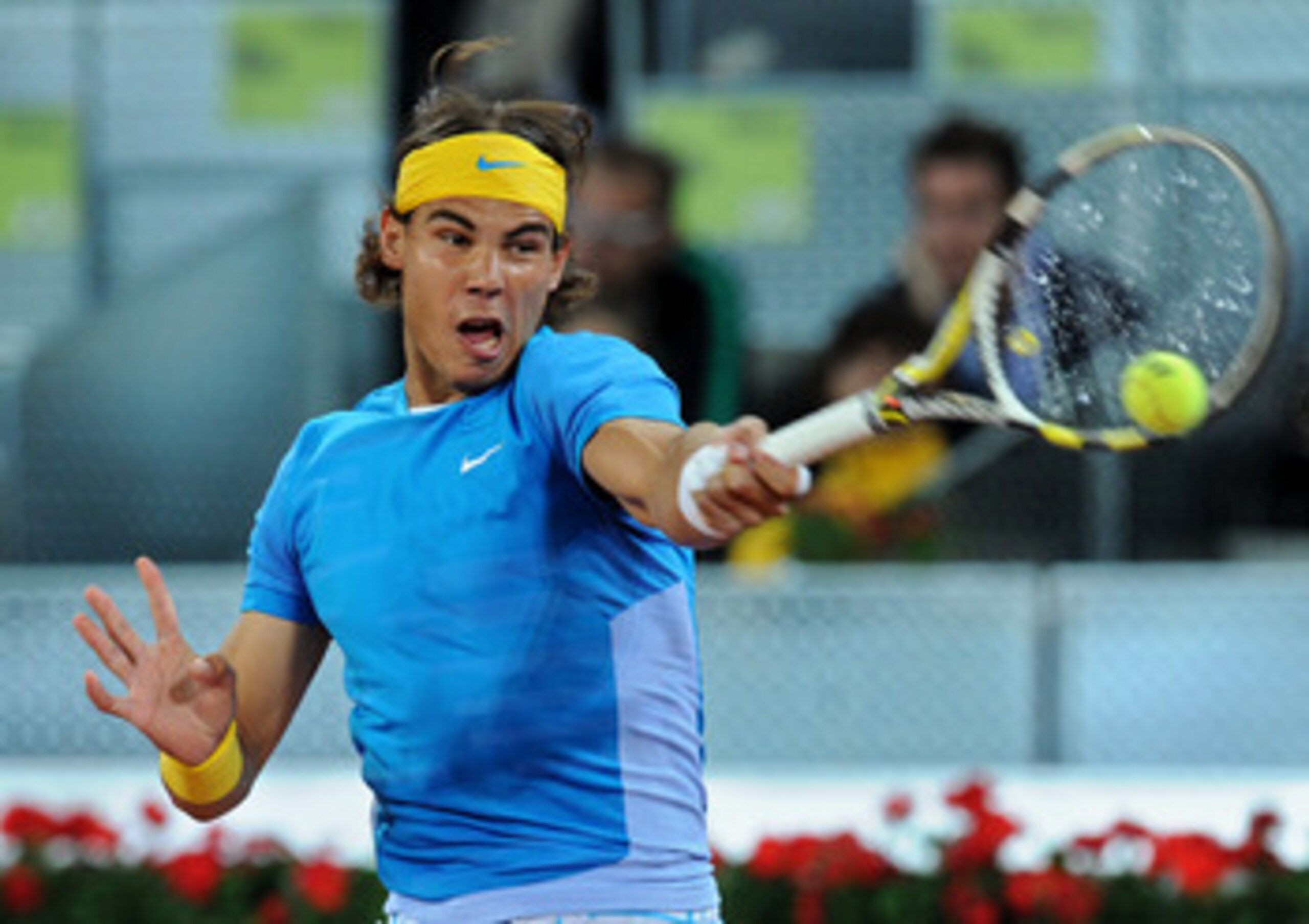 MADRID, SPAIN - MAY 13:  Rafael Nadal of Spain plays a backhand to John Isner of the USA in their third round match during the Mutua Madrilena Madrid Open tennis tournament at the Caja Magica on May 13, 2010 in Madrid, Spain.  (Photo by Jasper Juinen/Gett