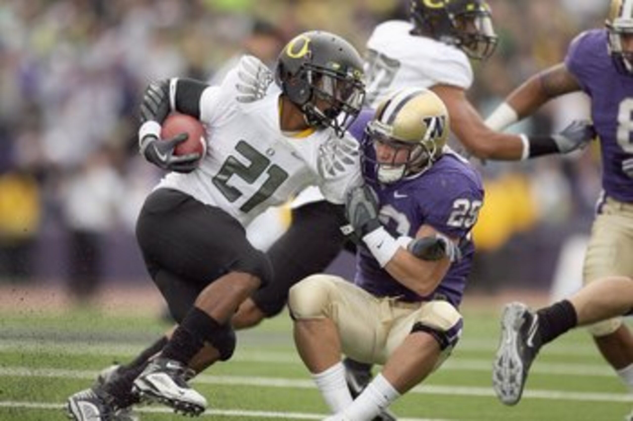 SEATTLE - OCTOBER 24:  LaMichael James #21 of the Oregon Ducks carries the ball against Nate Fellner #29 of the Washington Huskies on October 24, 2009 at Husky Stadium in Seattle, Washington. The Ducks defeated the Huskies 43-19. (Photo by Otto Greule Jr/