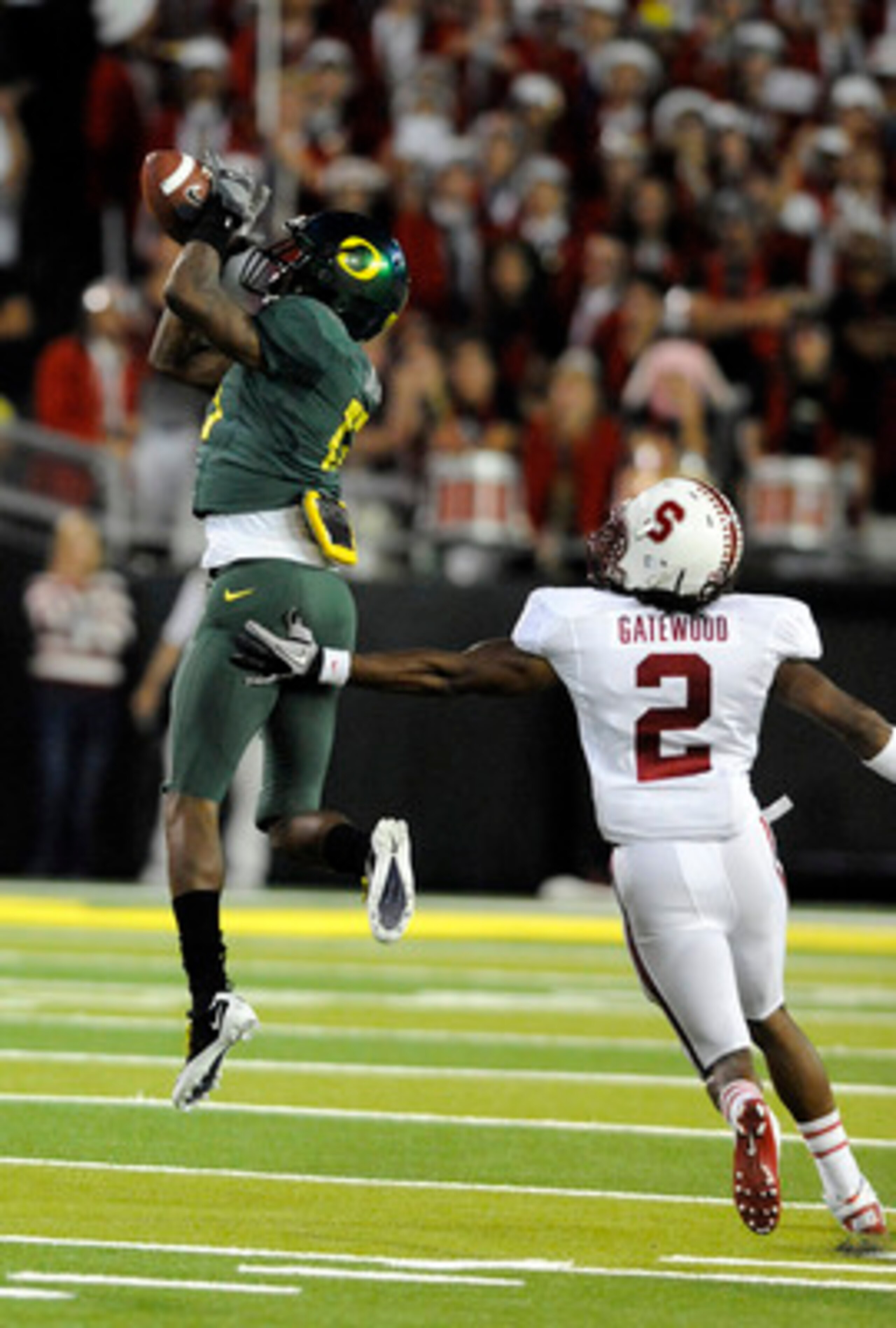 EUGENE, OR - OCTOBER 2: Cornerback Cliff Harris #13 of the Oregon Ducks intercepts a pass in front of cornerback Corey Gatewood #2 of the Stanford Cardinal in the third quarter of the game at Autzen Stadium on October 2, 2010 in Eugene, Oregon. Oregon won