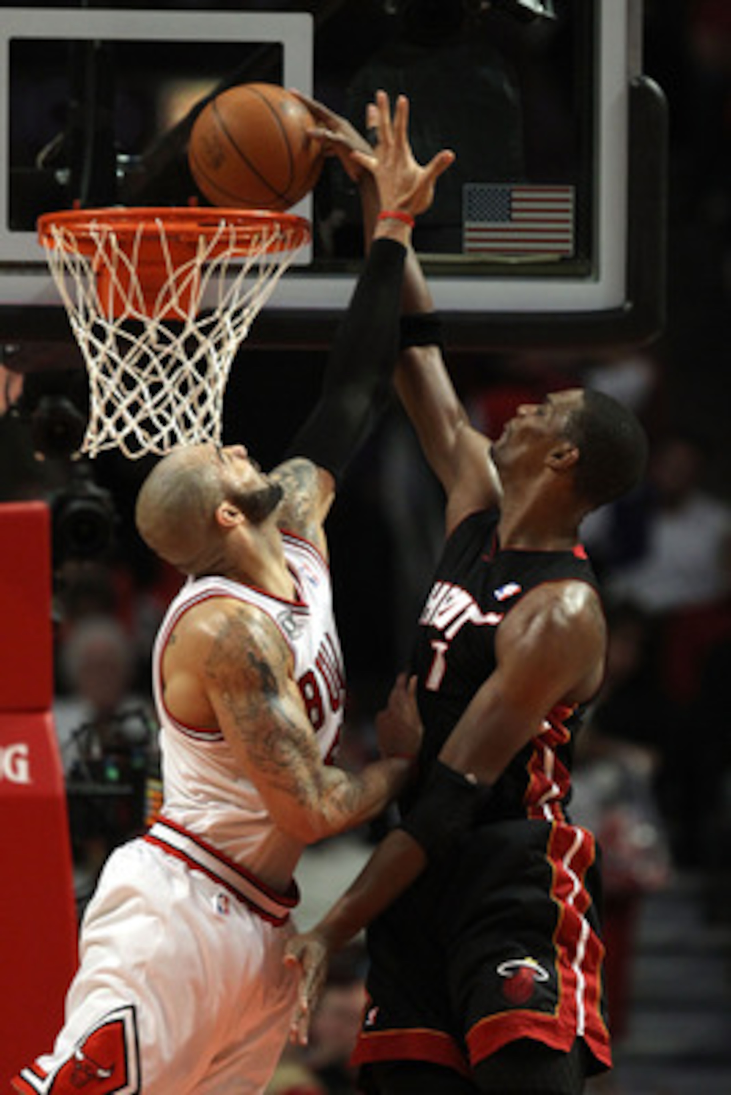 CHICAGO, IL - MAY 15:  Chris Bosh #1 of the Miami Heat dunks against Carlos Boozer #5 of the Chicago Bulls in Game One of the Eastern Conference Finals during the 2011 NBA Playoffs on May 15, 2011 at the United Center in Chicago, Illinois. The Bulls won 1