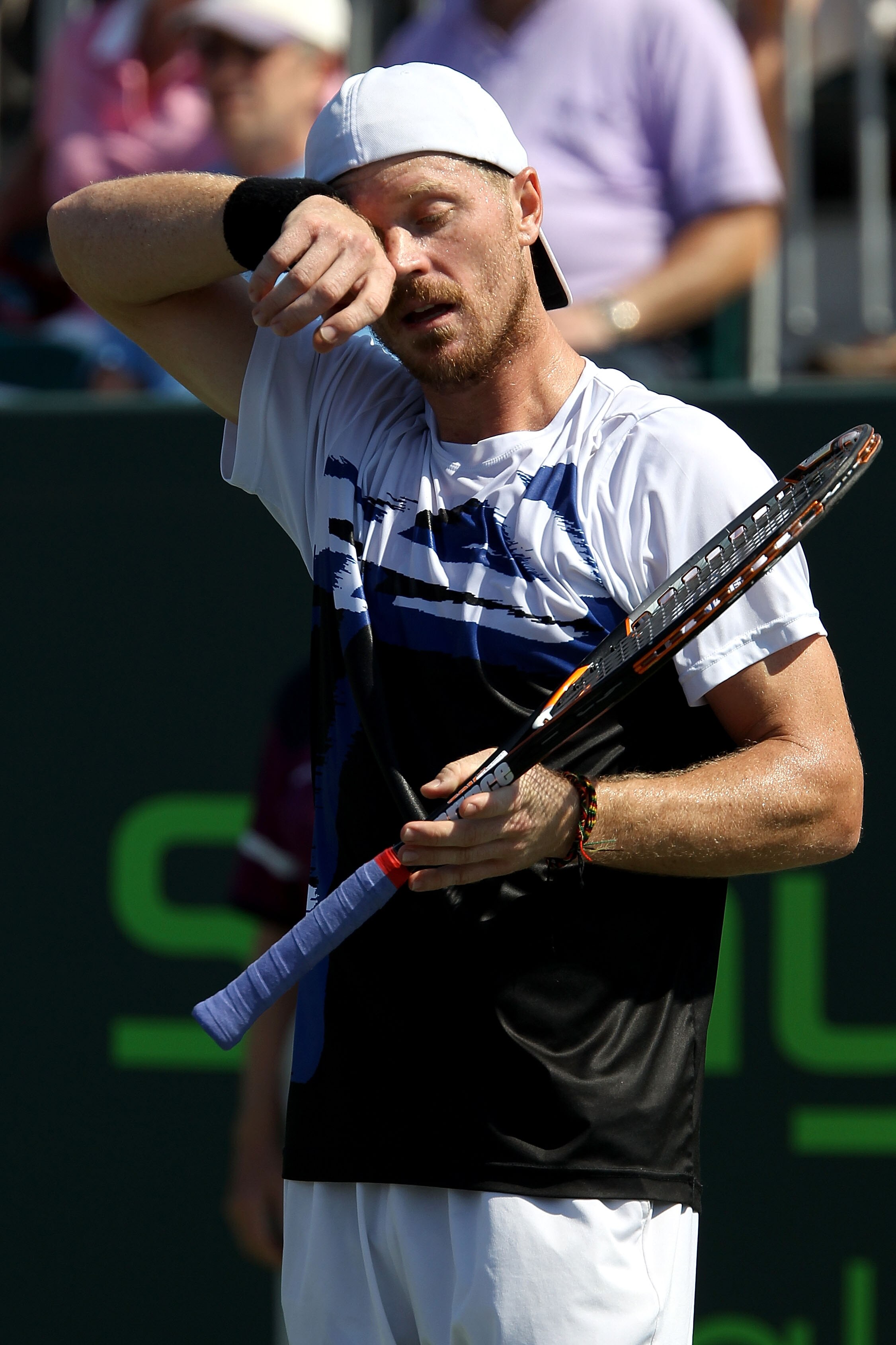 KEY BISCAYNE, FL - MARCH 27:  Alex Bogomolov Jr. wipes sweat off of his forehead against John Isner during the Sony Ericsson Open at Crandon Park Tennis Center on March 27, 2011 in Key Biscayne, Florida.  (Photo by Clive Brunskill/Getty Images)