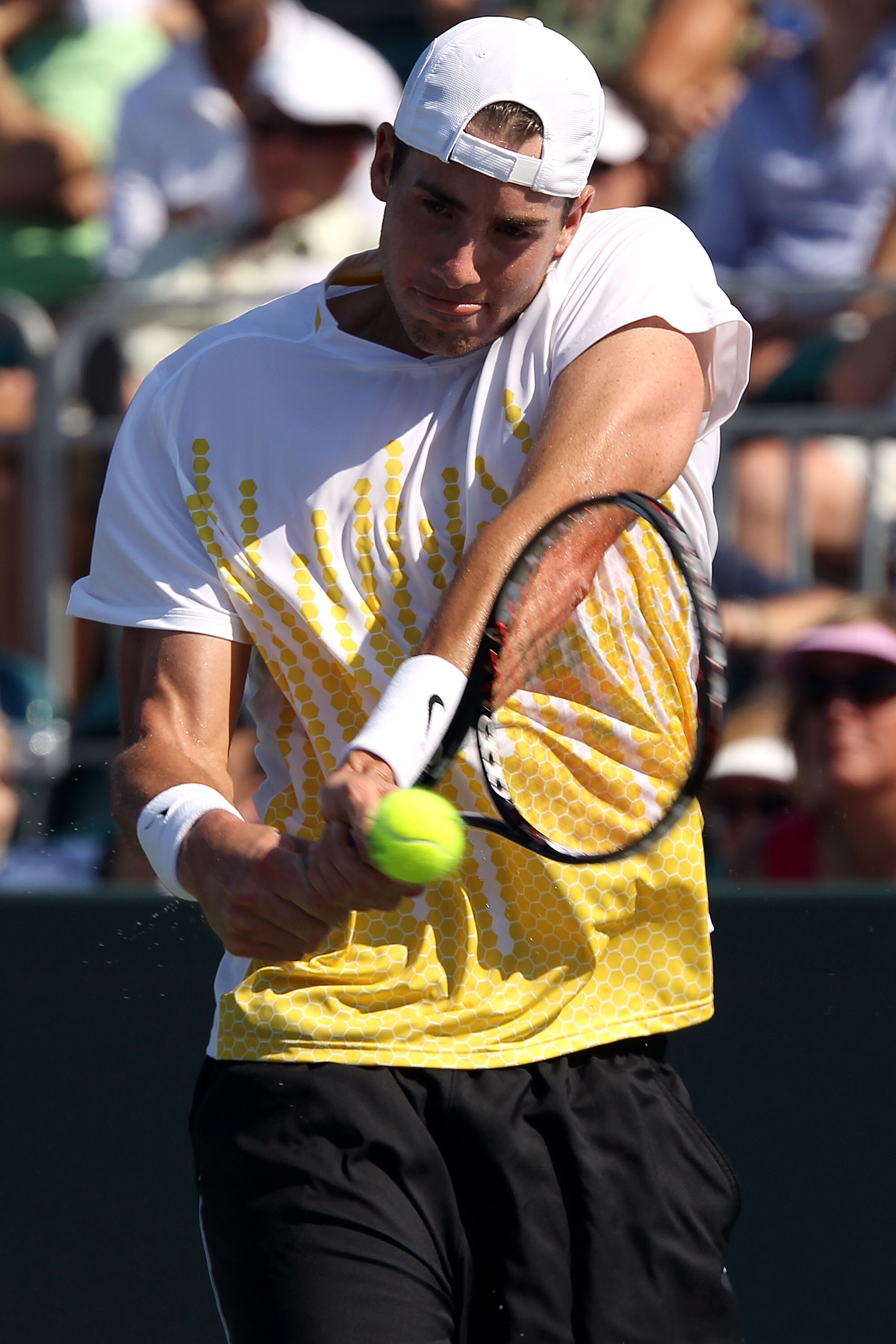 KEY BISCAYNE, FL - MARCH 27:  John Isner gets set to hit a backhand return against Alex Bogomolov Jr. during the Sony Ericsson Open at Crandon Park Tennis Center on March 27, 2011 in Key Biscayne, Florida.  (Photo by Clive Brunskill/Getty Images)