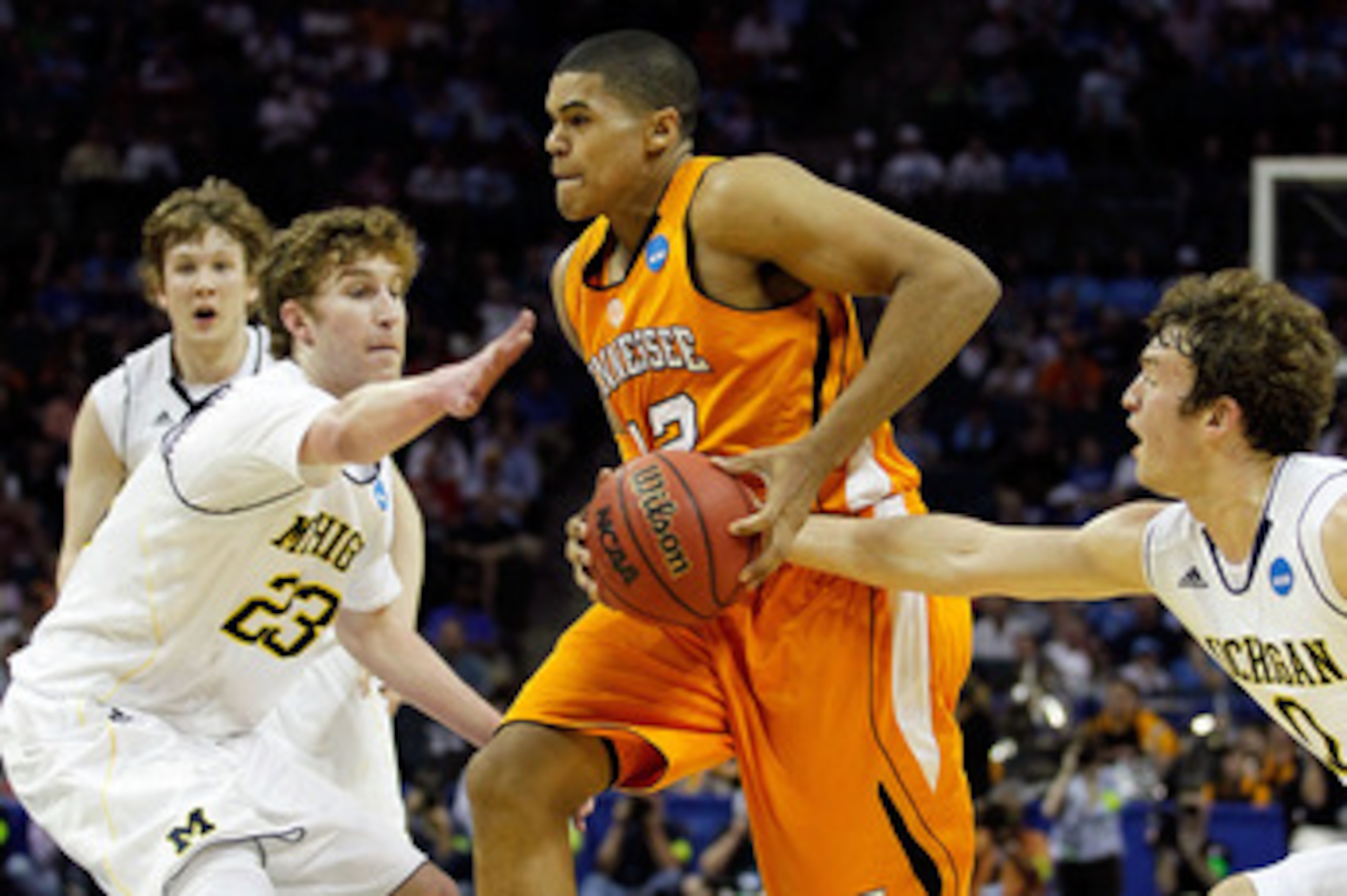 CHARLOTTE, NC - MARCH 18: Tobias Harris #12 of the Tennessee Volunteers drives through Evan Smotrycz #23 and Zack Novak #0 of the Michigan Wolverines in the first half during the second round of the 2011 NCAA men's basketball tournament at Time Warner Ca CHARLOTTE, NC - MARCH 18: Tobias Harris #12 of the Tennessee Volunteers drives through Evan Smotrycz #23 and Zack Novak #0 of the Michigan Wolverines in the first half during the second round of the 2011 NCAA men's basketball tournament at Time Warner Ca