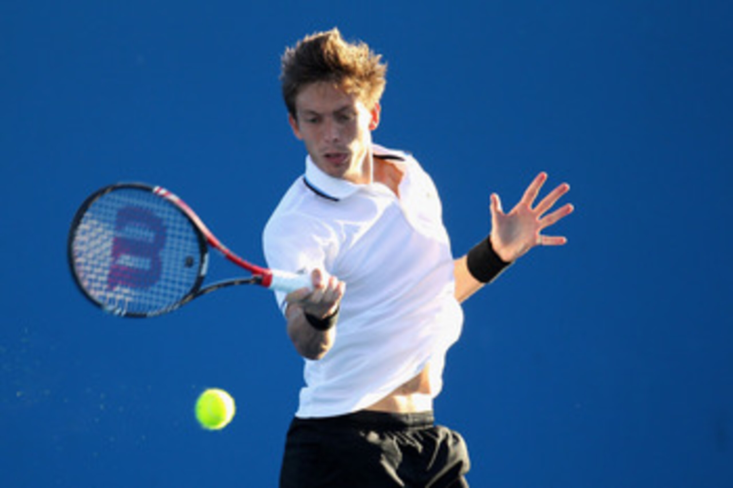MELBOURNE, AUSTRALIA - JANUARY 19:  Nicolas Mahut of France plays a forehand during his second round match against Viktor Troicki of Serbia during day three of the 2011 Australian Open at Melbourne Park on January 19, 2011 in Melbourne, Australia.  (Photo