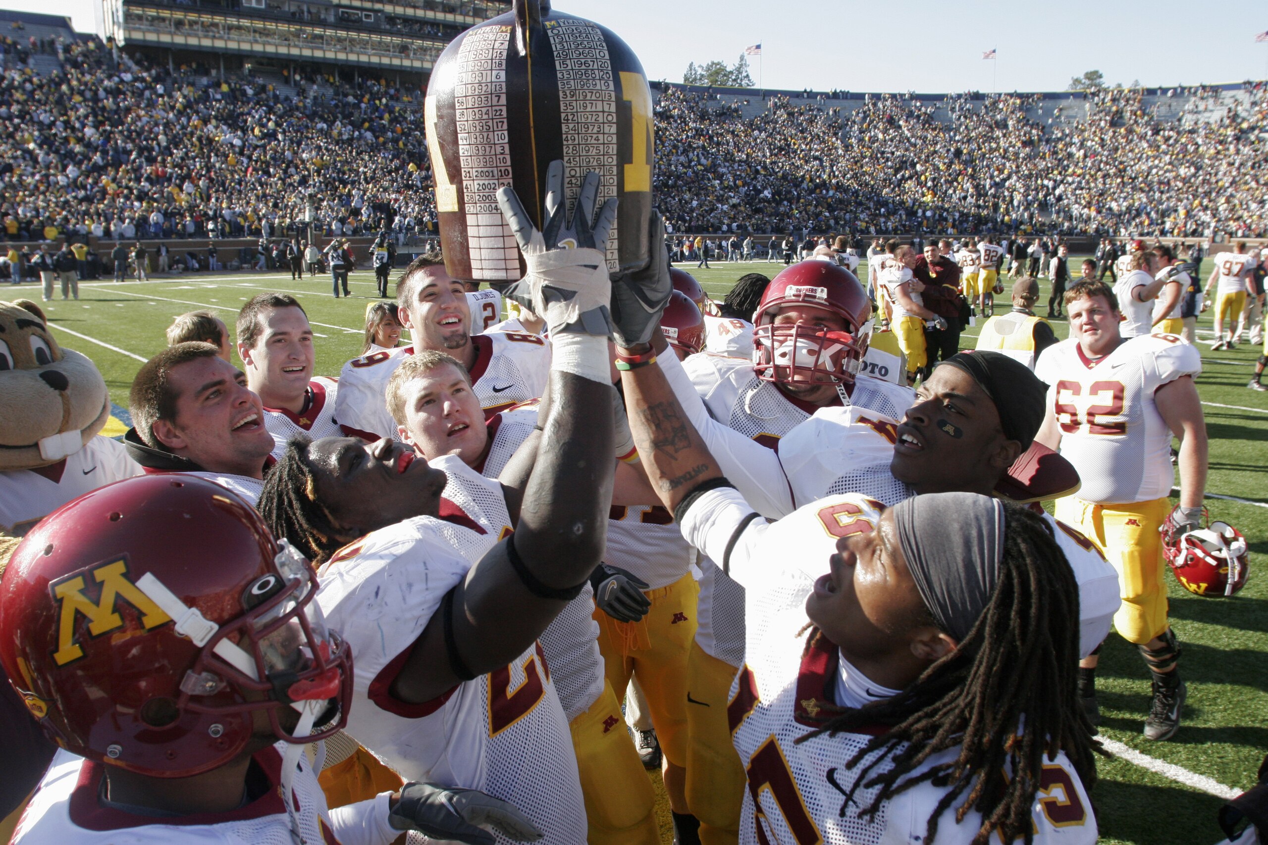 ANN ARBOR - OCTOBER 8:  The Minnesota Gophers celebrate their win after the game against the Michigan Wolverines at Michigan Stadium on October 8, 2005 in Ann Arbor, Michigan.  The pass was incomplete. Minnesota won 23-20. (Photo by Tom Pidgeon/Getty Imag