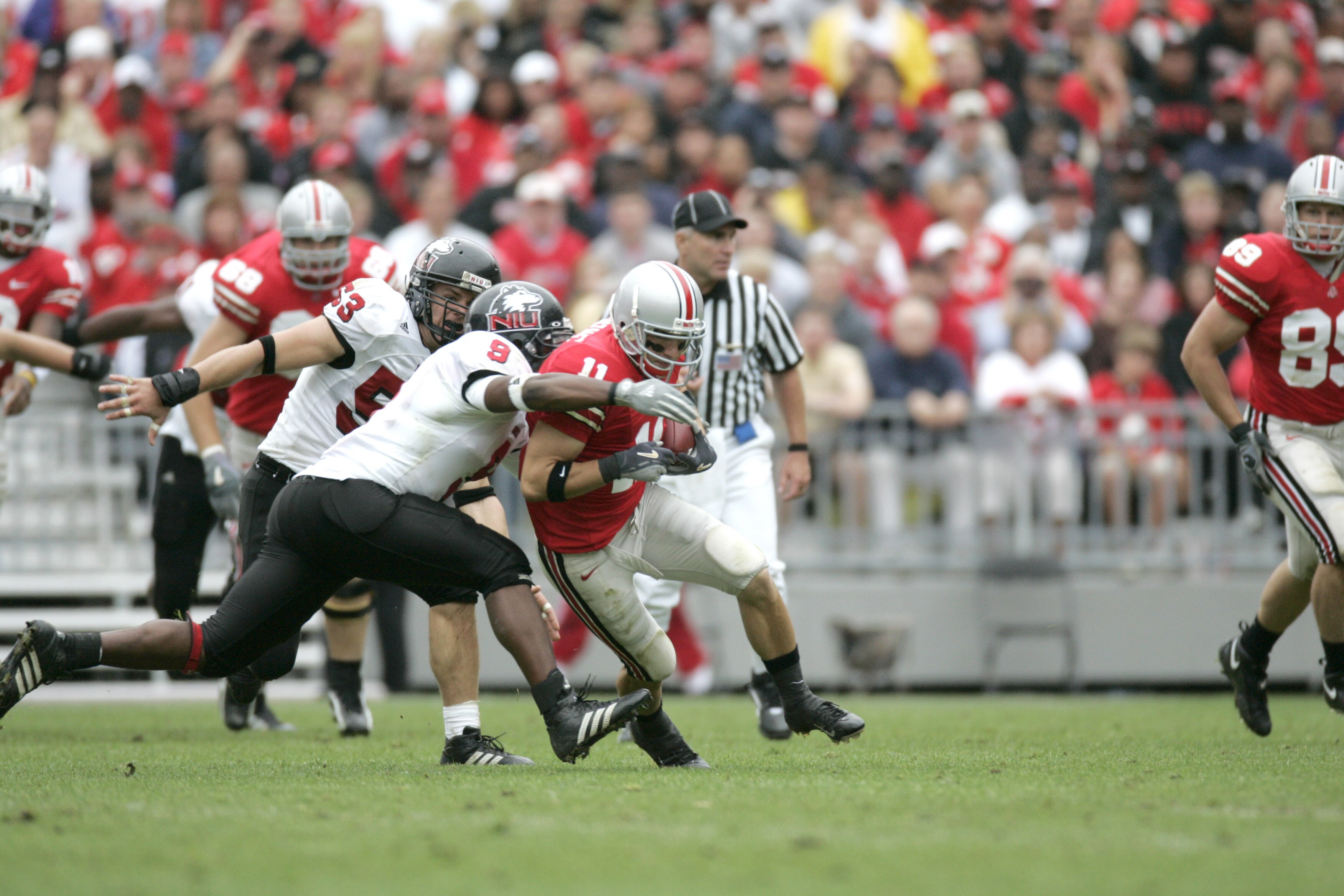 COLUMBUS, OH - SEPTEMBER 2:  Split end Anthony Gonzalez #11 of the Ohio State University Buckeyes is tackled by linebacker Josh Allen #9 of the Northern Illinois University Huskies during the game on September 2, 2006 at Ohio Stadium in Columbus, Ohio. OS