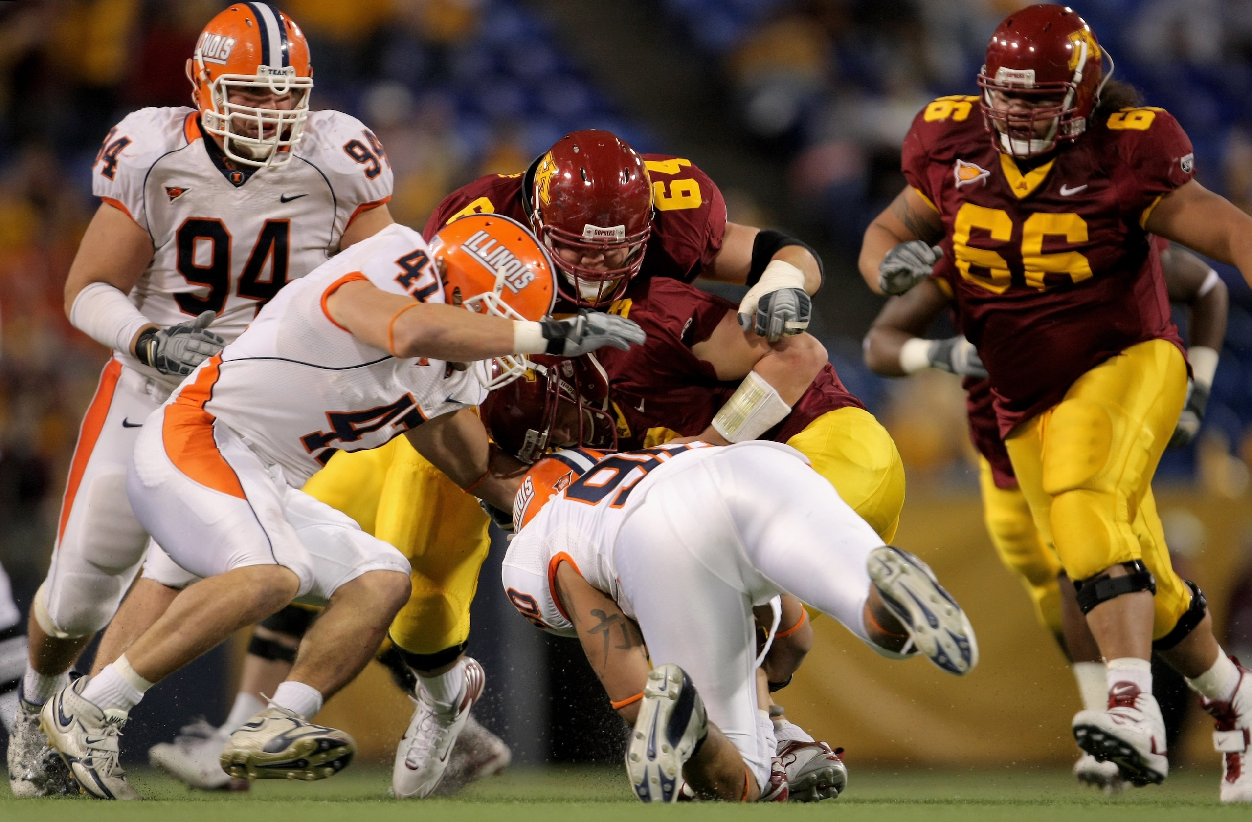 MINNEAPOLIS, MN - NOVEMBER 03:  Quarterback Adam Weber #8 of the Minnesota Golden Gophers is sacked by Antonio James #90 of the Illinois Fighting Illini as J Leman #47 of the Illini and Steve Shindell #64 of the Gophers join the play at the Hubert H. Hump