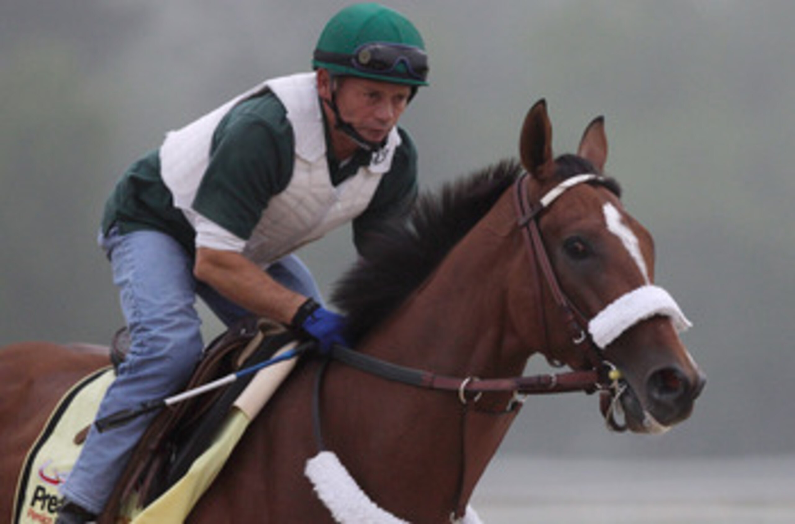 BALTIMORE, MD - MAY 19:  Exercise rider Heriberto Pulgar takes Preakness entrant Mucho Macho Man over the track at Pimlico Race Course on May 19, 2011 in Baltimore, Maryland. The 136th running of the Preakness Stakes will be run on Saturday.  (Photo by Ro