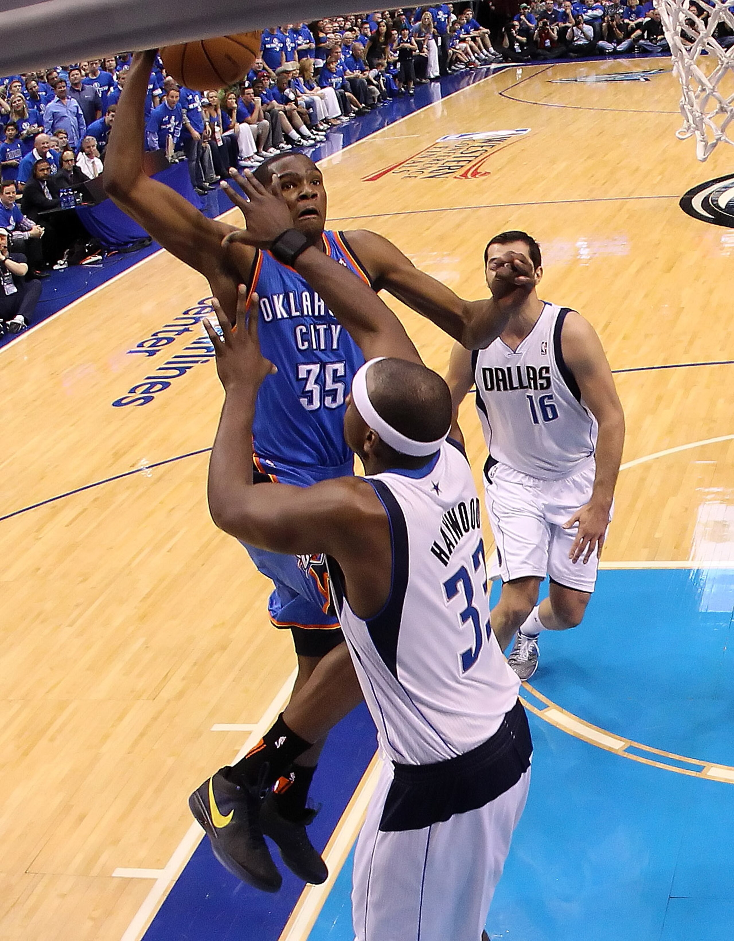 DALLAS, TX - MAY 19:  Kevin Durant #35 of the Oklahoma City Thunder dunks the ball over Brendan Haywood #33 of the Dallas Mavericks as Haywood is called for a foul in the first quarter in Game Two of the Western Conference Finals during the 2011 NBA Playo