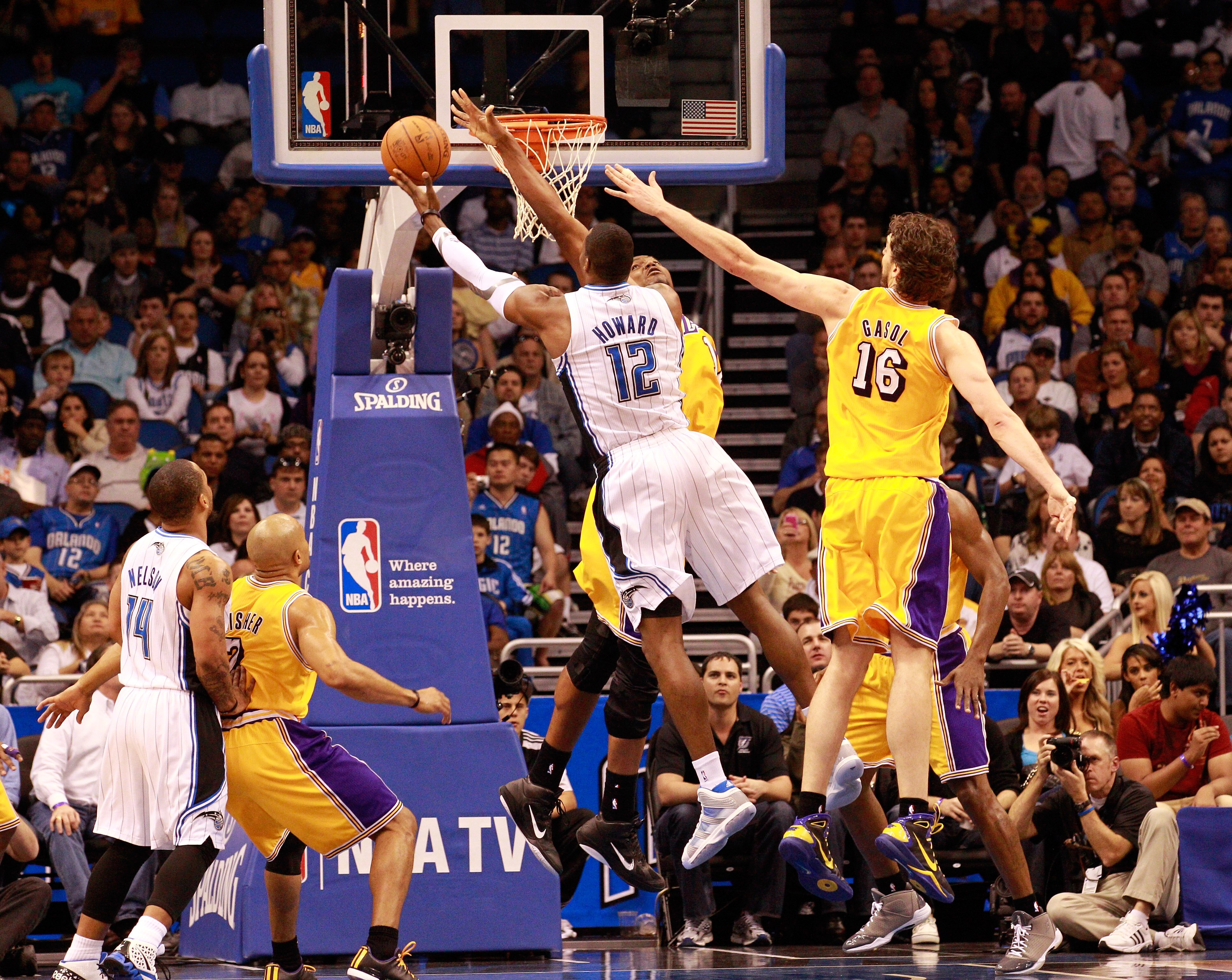 ORLANDO, FL - FEBRUARY 13:  Dwight Howard #12 of the Orlando Magic attempts a shot over Pau Gasol #16 and Andrew Bynum #17 of the Los Angeles Lakers during the game at Amway Arena on February 13, 2011 in Orlando, Florida.  NOTE TO USER: User expressly ack