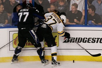 TAMPA, FL - MAY 19:  Victor Hedman #77 of the Tampa Bay Lightning checks Patrice Bergeron #37 of the Boston Bruins in Game Three of the Eastern Conference Finals during the 2011 NHL Stanley Cup Playoffs at St Pete Times Forum on May 19, 2011 in Tampa, Flo