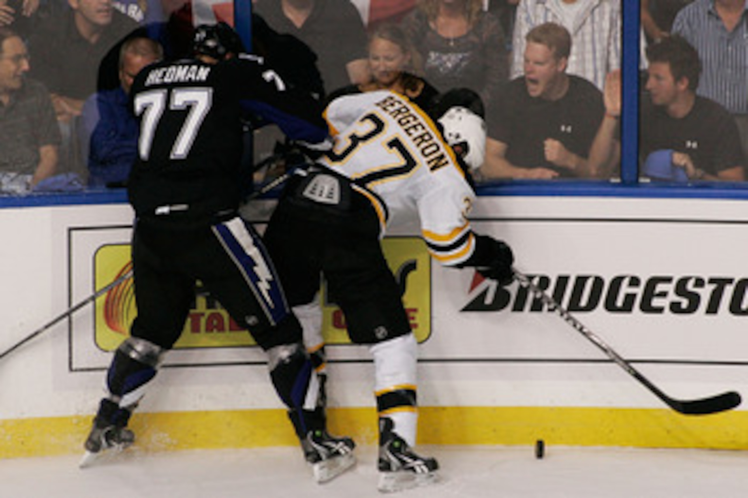 TAMPA, FL - MAY 19:  Victor Hedman #77 of the Tampa Bay Lightning checks Patrice Bergeron #37 of the Boston Bruins in Game Three of the Eastern Conference Finals during the 2011 NHL Stanley Cup Playoffs at St Pete Times Forum on May 19, 2011 in Tampa, Flo