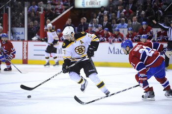 MONTREAL, CANADA - APRIL 21:  Patrice Bergeron #37 of the Boston Bruins looks to deke around Brian Gionta #21 of the Montreal Canadiens in Game Four of the Eastern Conference Quarterfinals during the 2011 NHL Stanley Cup Playoffs at the Bell Centre on Apr