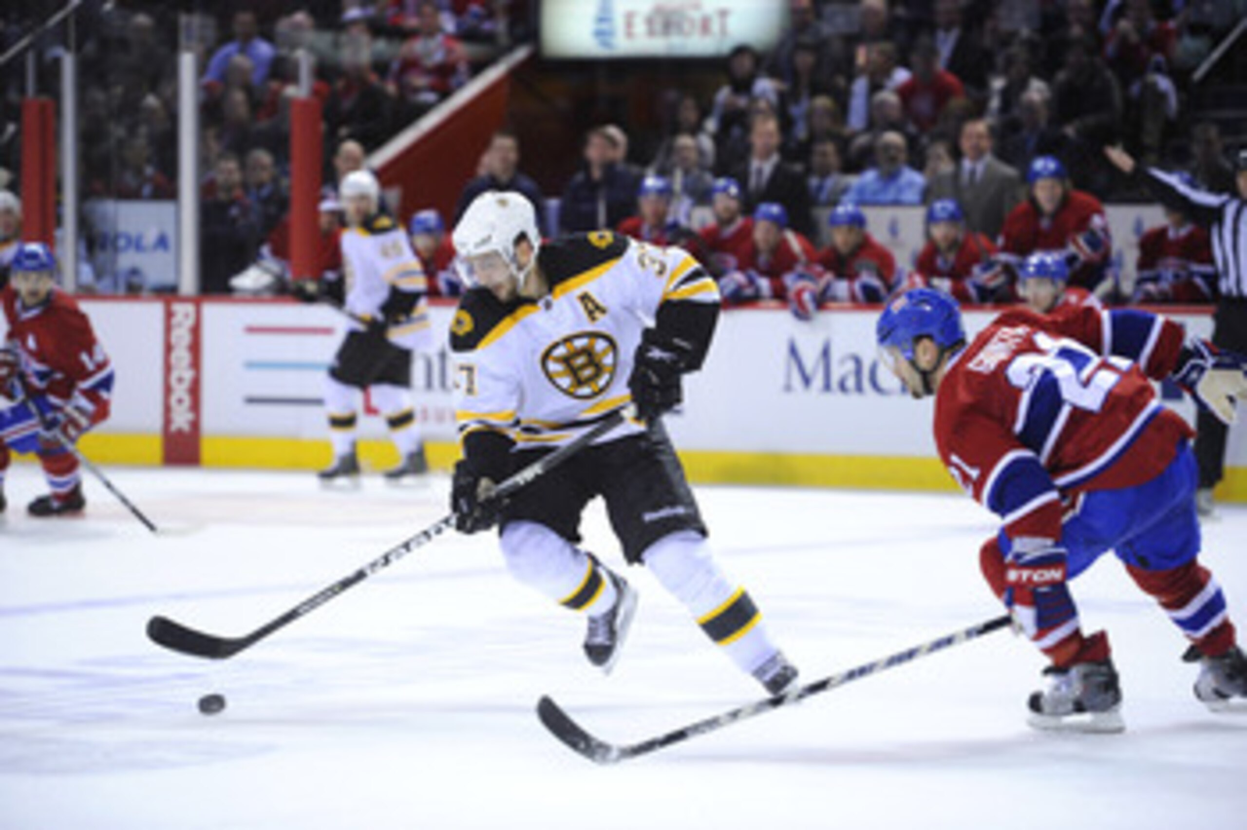 MONTREAL, CANADA - APRIL 21:  Patrice Bergeron #37 of the Boston Bruins looks to deke around Brian Gionta #21 of the Montreal Canadiens in Game Four of the Eastern Conference Quarterfinals during the 2011 NHL Stanley Cup Playoffs at the Bell Centre on Apr