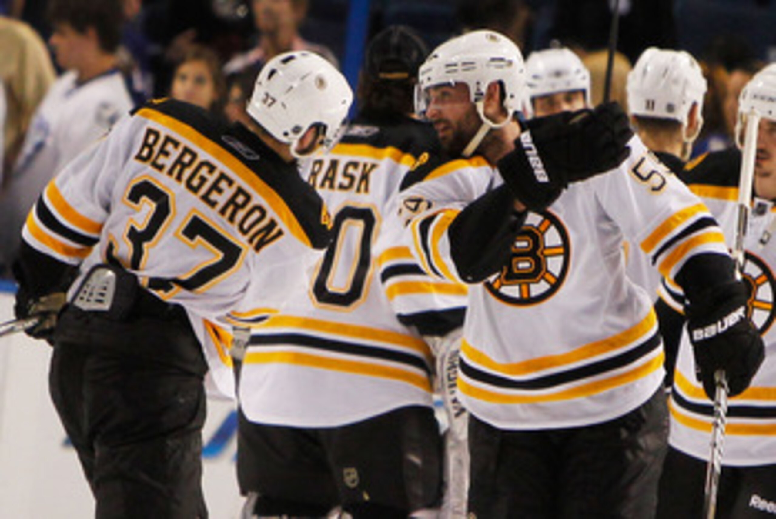 TAMPA, FL - MAY 19:  Patrice Bergeron #37 and Johnny Boychuk #55 of the Boston Bruins celebrate defeating the Tampa Bay Lightning 2 to 0 in Game Three of the Eastern Conference Finals during the 2011 NHL Stanley Cup Playoffs at St Pete Times Forum on May 