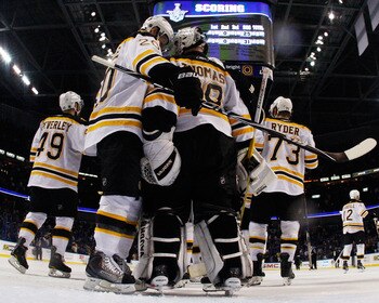 TAMPA, FL - MAY 19:  Tim Thomas #30 and Daniel Paille #20 of the Boston Bruins celebrate with their teammates after they defeated the Tampa Bay Lightning 2 to 0 in Game Three of the Eastern Conference Finals during the 2011 NHL Stanley Cup Playoffs at St 