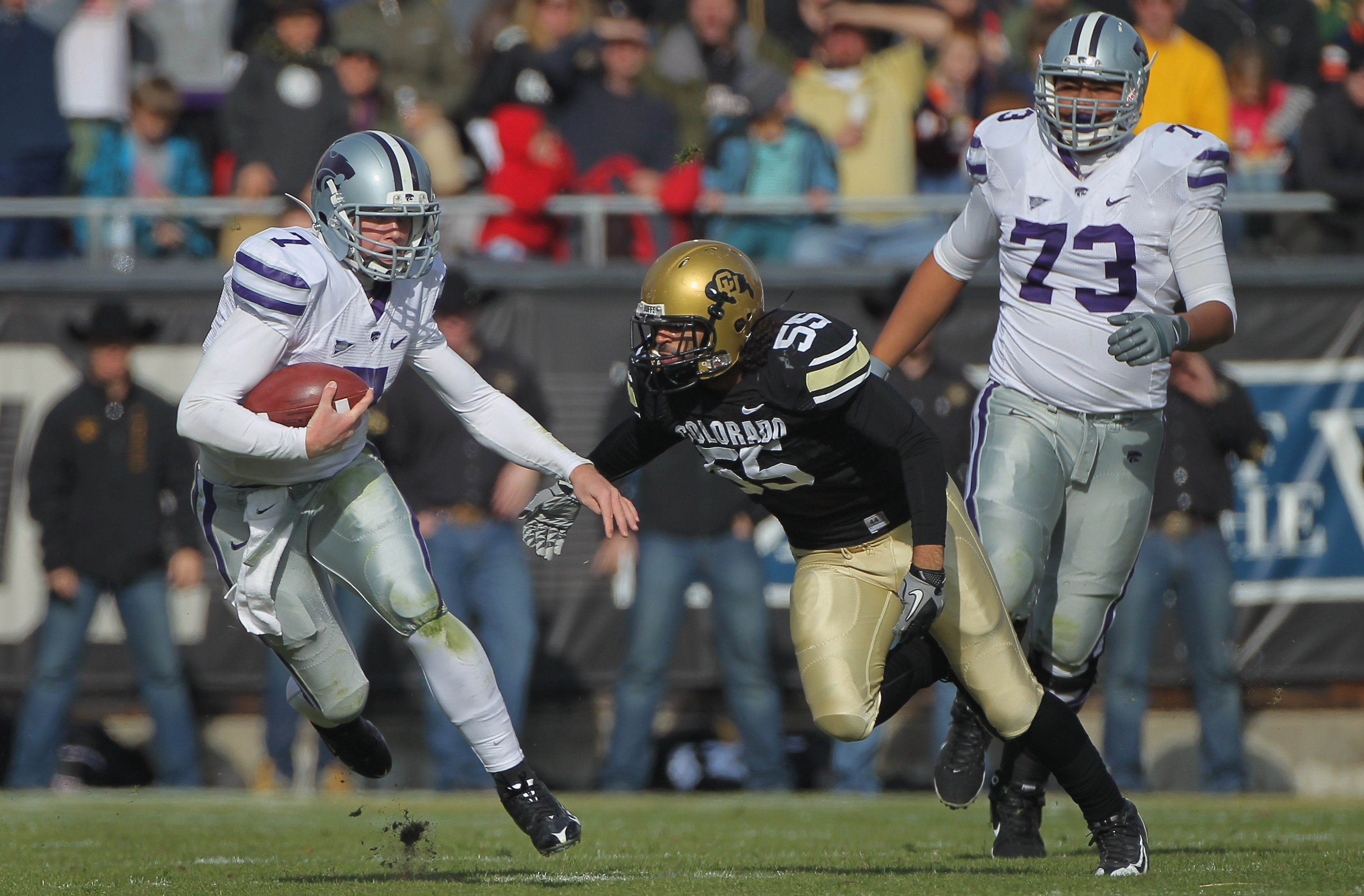 BOULDER, CO - NOVEMBER 20:  Quarterback Collin Klein #7 of the Kansas State Wildcats rushes with the ball as Josh Hartigan #55 of the Colorado Buffaloes closes in for the tackle at Folsom Field on November 20, 2010 in Boulder, Colorado. Colorado defeated