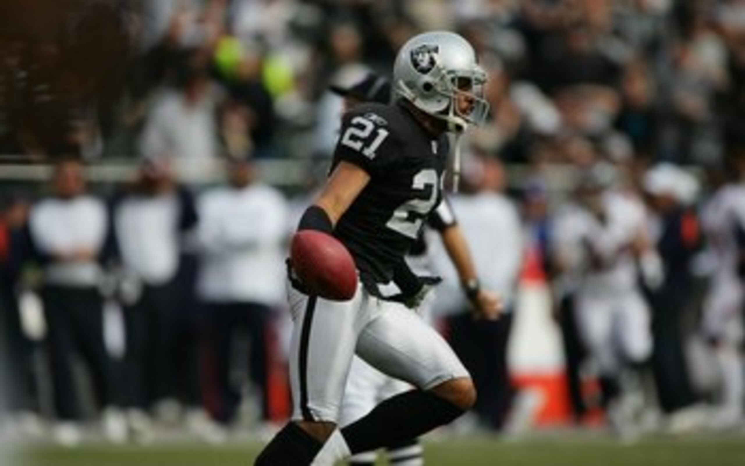 OAKLAND, CA - NOVEMBER 12:  Cornerback Nnamdi Asomugha #21 of the Oakland Raiders celebrates an interception against the Denver Broncos at McAfee Coliseum on November 12, 2006 in Oakland, California. The Broncos defeated the Raiders 17-13. (Photo by Jed J