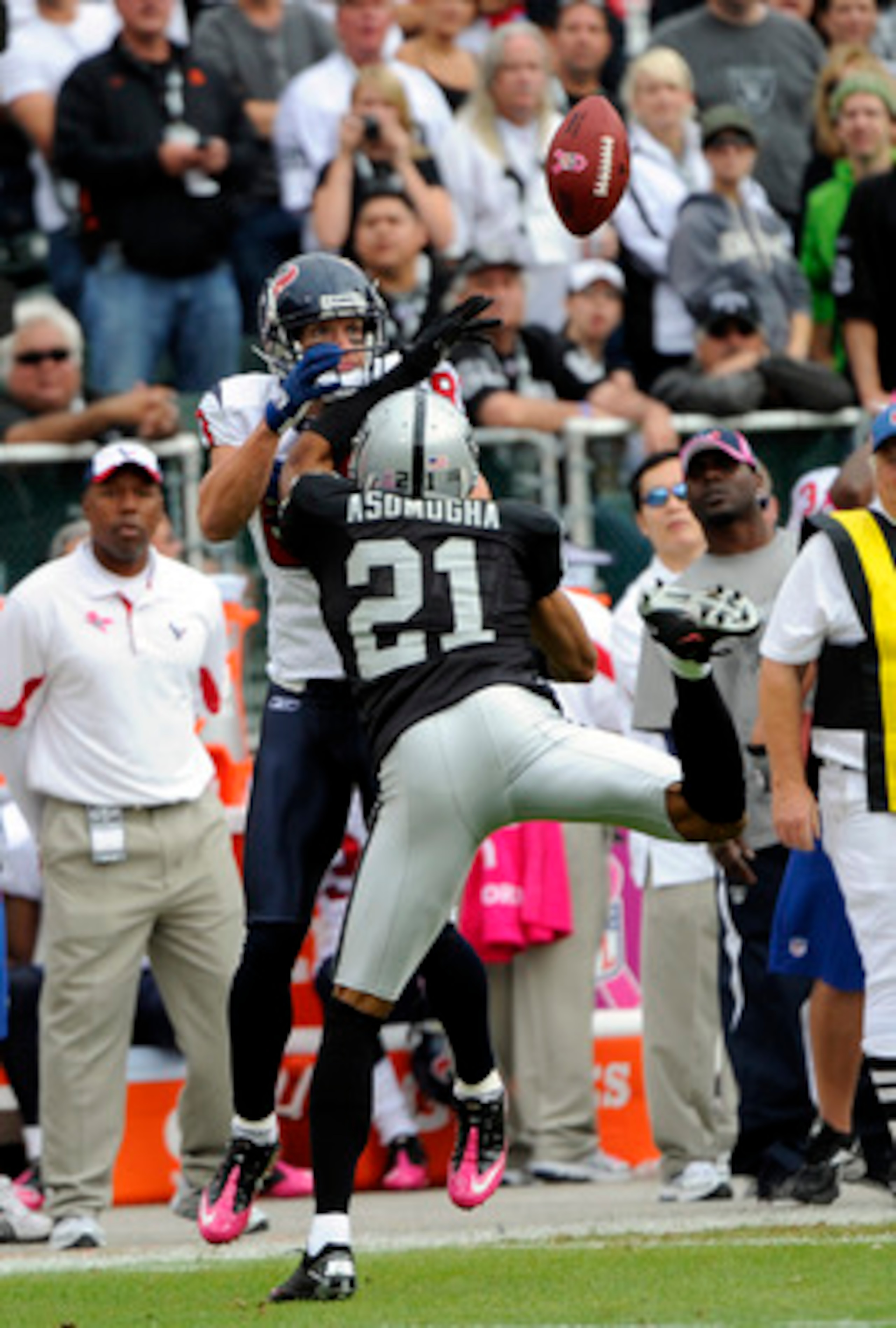 OAKLAND, CA - OCTOBER 3:  Defensive back Nnamdi Asomugha #21 of the Oakland Raiders breaks up a pass to wide receiver Kevin Walter #83 of the Houston Texans during an NFL football game October 3, 2010 at The Oakland-Alameda County Coliseum in Oakland, Cal
