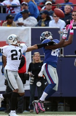 EAST RUTHERFORD, NJ - OCTOBER 11:  Hakeem Nicks #88 of the New York Giants attempts a catch against Nnamdi Asomugha #21 of the Oakland Raiders on October 11, 2009 at Giants Stadium in East Rutherford, New Jersey. The Giants defeated the Raiders 44-7.  (Ph