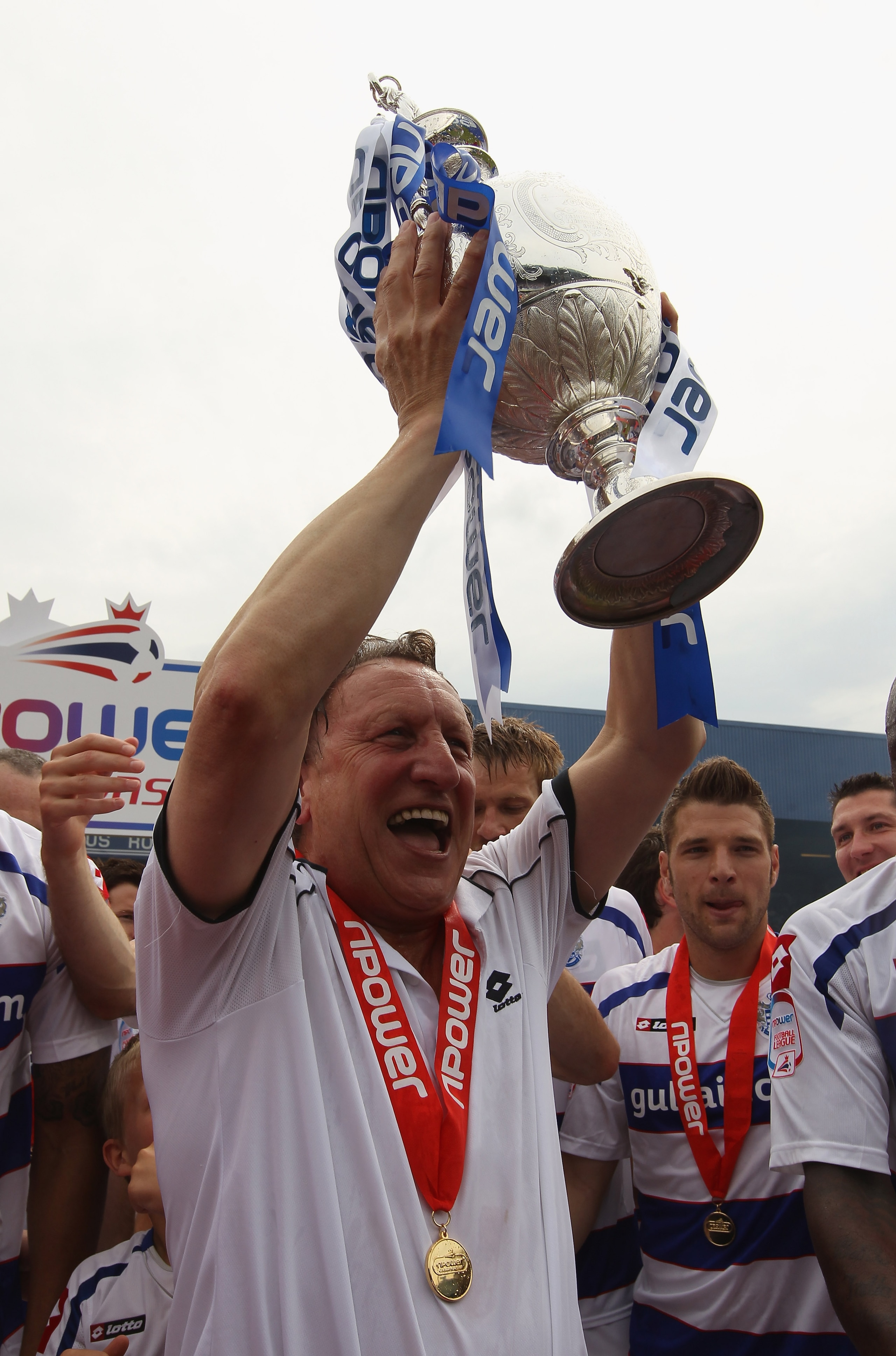 LONDON, ENGLAND - MAY 07:  QPR manager Neil Warnock celebrates with the trophy after winning the npower Championship match between Queens Park Rangers and Leeds United at Loftus Road on May 7, 2011 in London, England.  (Photo by Ian Walton/Getty Images)