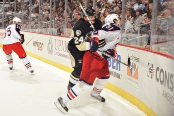 PITTSBURGH, PA - FEBRUARY 8:  Matt Cooke #24 of the Pittsburgh Penguins checks Fedor Tyutin #51 of the Columbus Blue Jackets in the first period on February 8, 2011 at CONSOL Energy Center in Pittsburgh, Pennsylvania. Cooke was assessed a five-minute majo