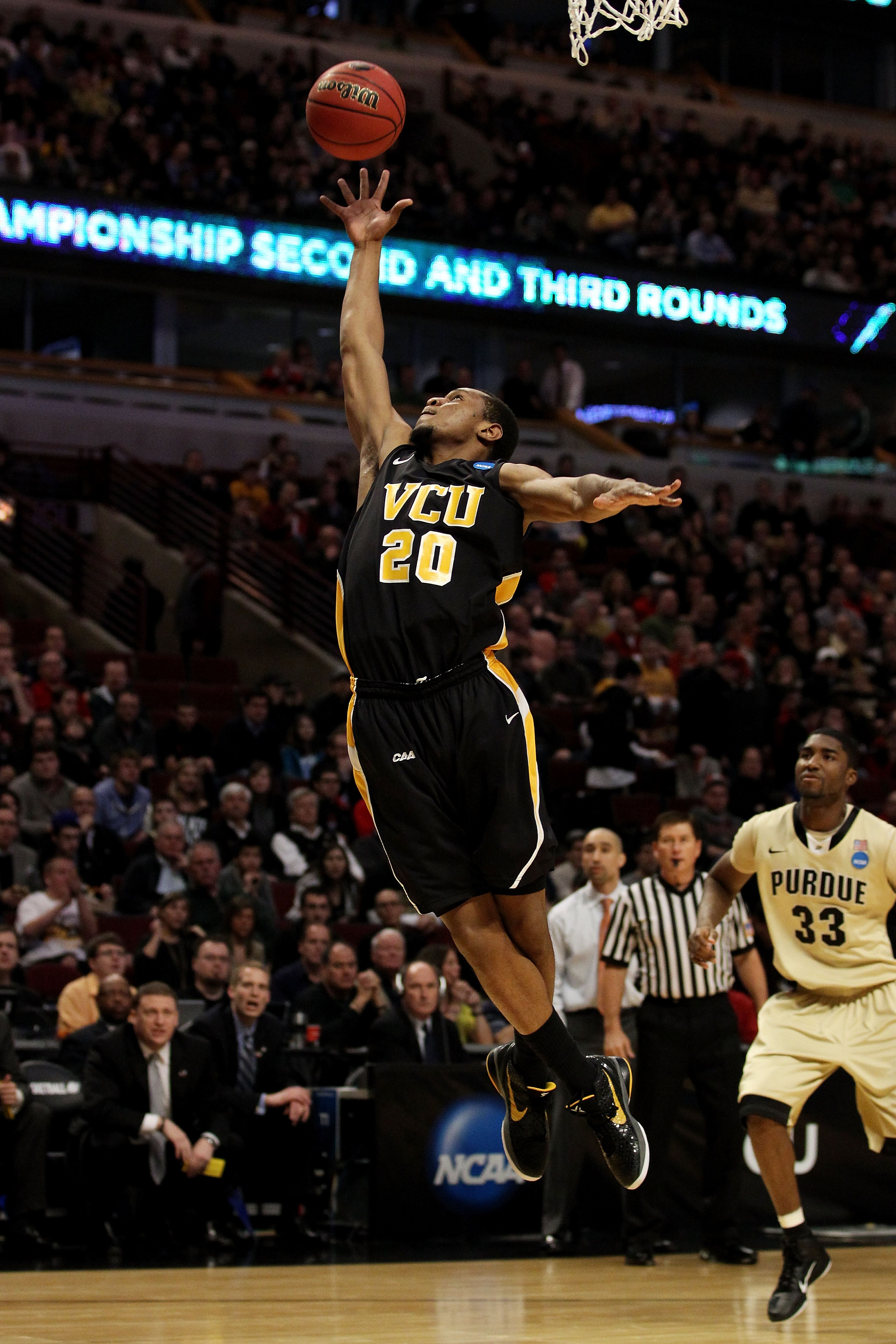 CHICAGO, IL - MARCH 20:  Bradford Burgess #20 of the Virginia Commonwealth Rams rebounds the ball against E'Twaun Moore #33 of the Purdue Boilermakers in the first half during the third round of the 2011 NCAA men's basketball tournament at the United Cent