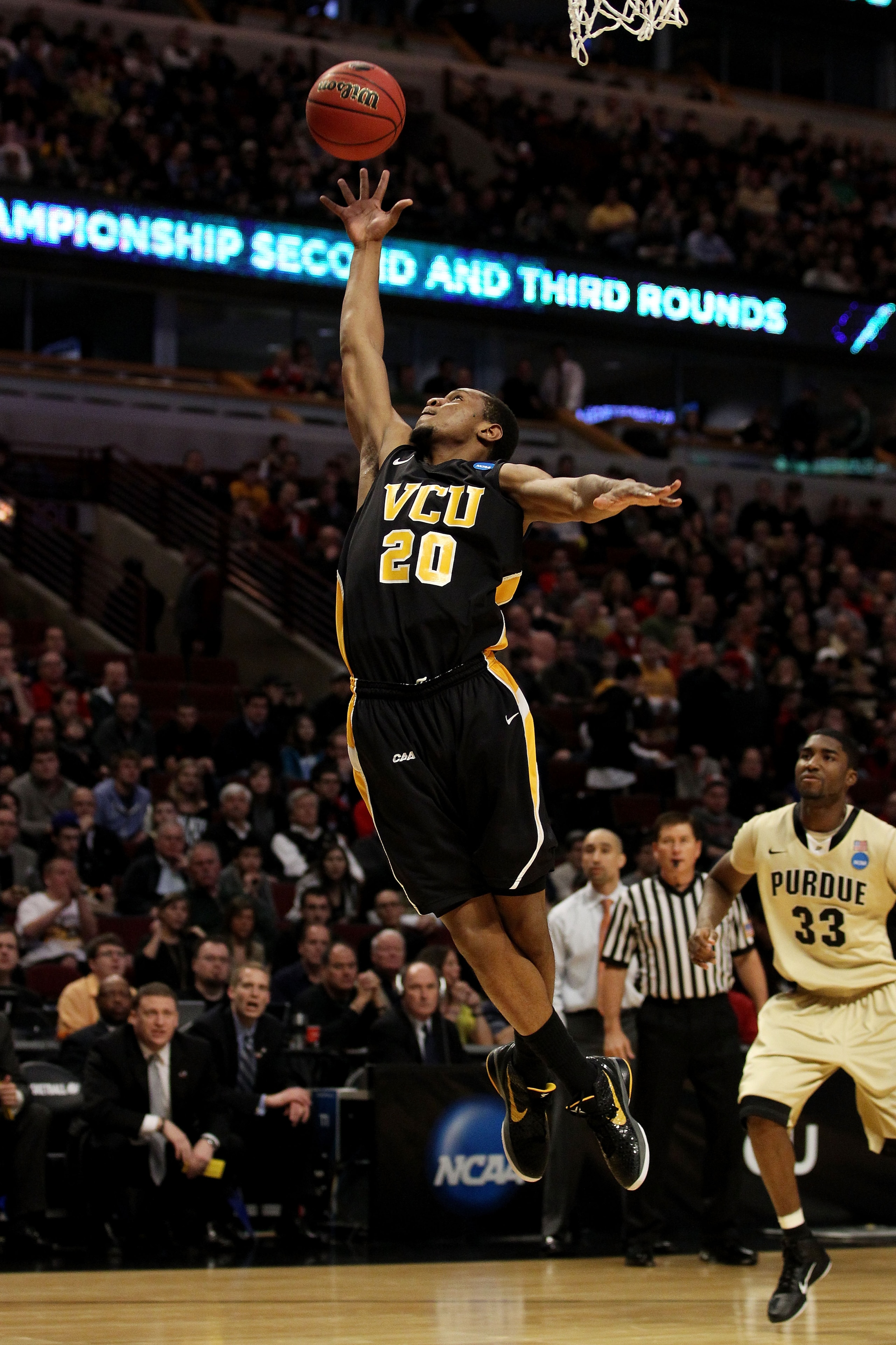 CHICAGO, IL - MARCH 20:  Bradford Burgess #20 of the Virginia Commonwealth Rams rebounds the ball against E'Twaun Moore #33 of the Purdue Boilermakers in the first half during the third round of the 2011 NCAA men's basketball tournament at the United Cent