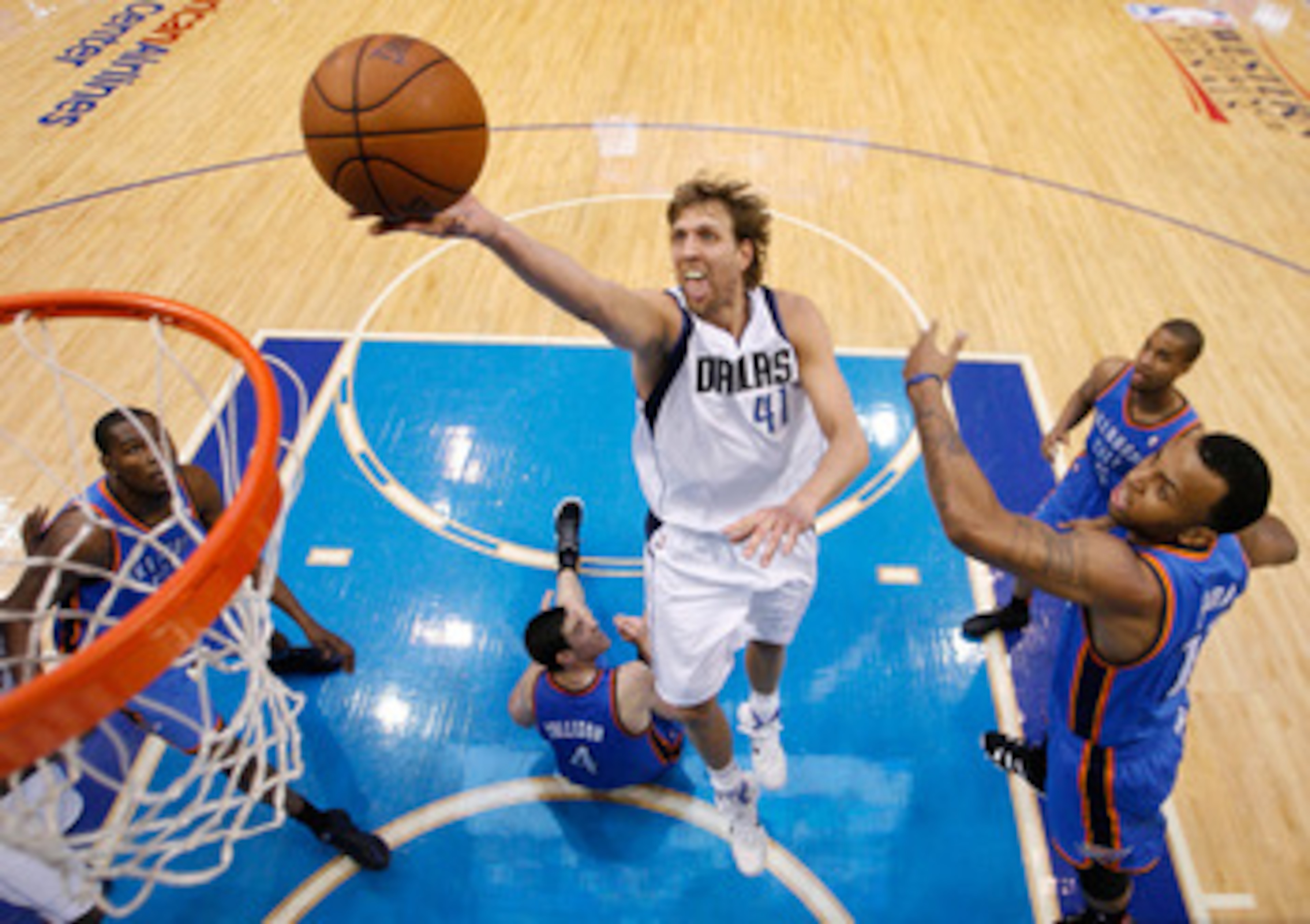 DALLAS, TX - MAY 19:  Dirk Nowitzki #41 of the Dallas Mavericks goes up for a shot past Nick Collison #4 of the Oklahoma City Thunder in the second half in Game Two of the Western Conference Finals during the 2011 NBA Playoffs at American Airlines Center