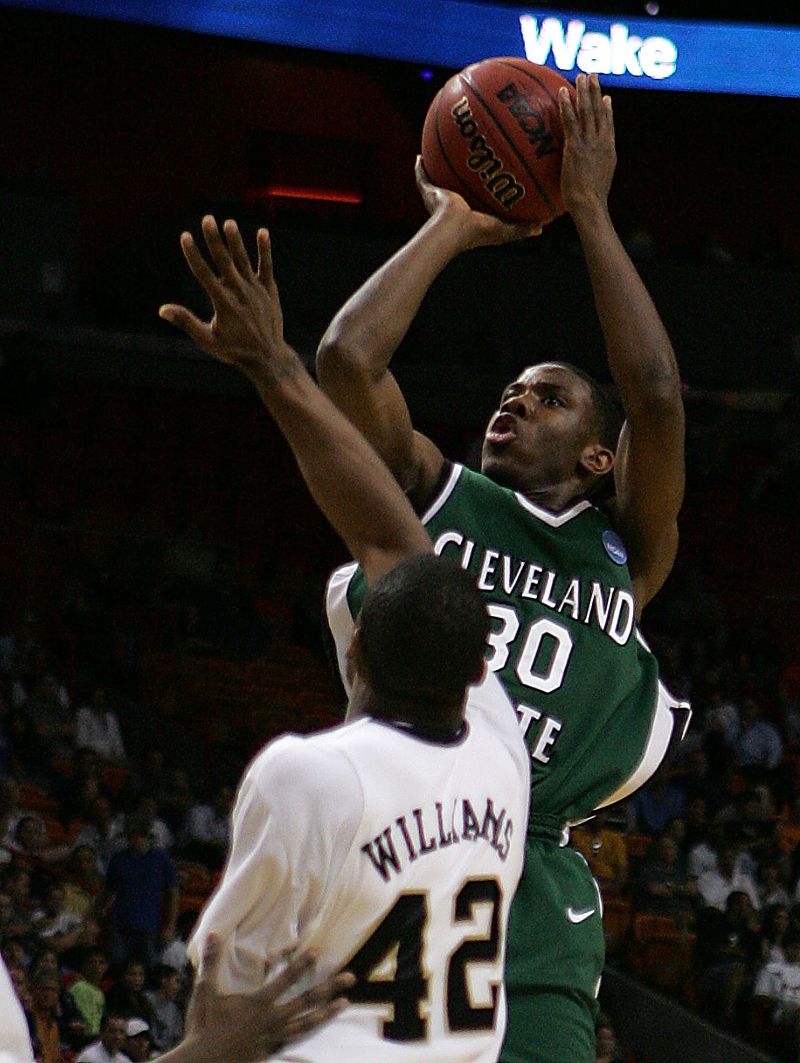 MIAMI - MARCH 20:  Guard Norris Cole #30 (R) of the Cleveland State University Vikings takes a shot over  guard L.D. Williams #42 (L) of Wake Forest Demon Deacons during the first round of the NCAA Division I Men's Basketball Tournament at the American Ai