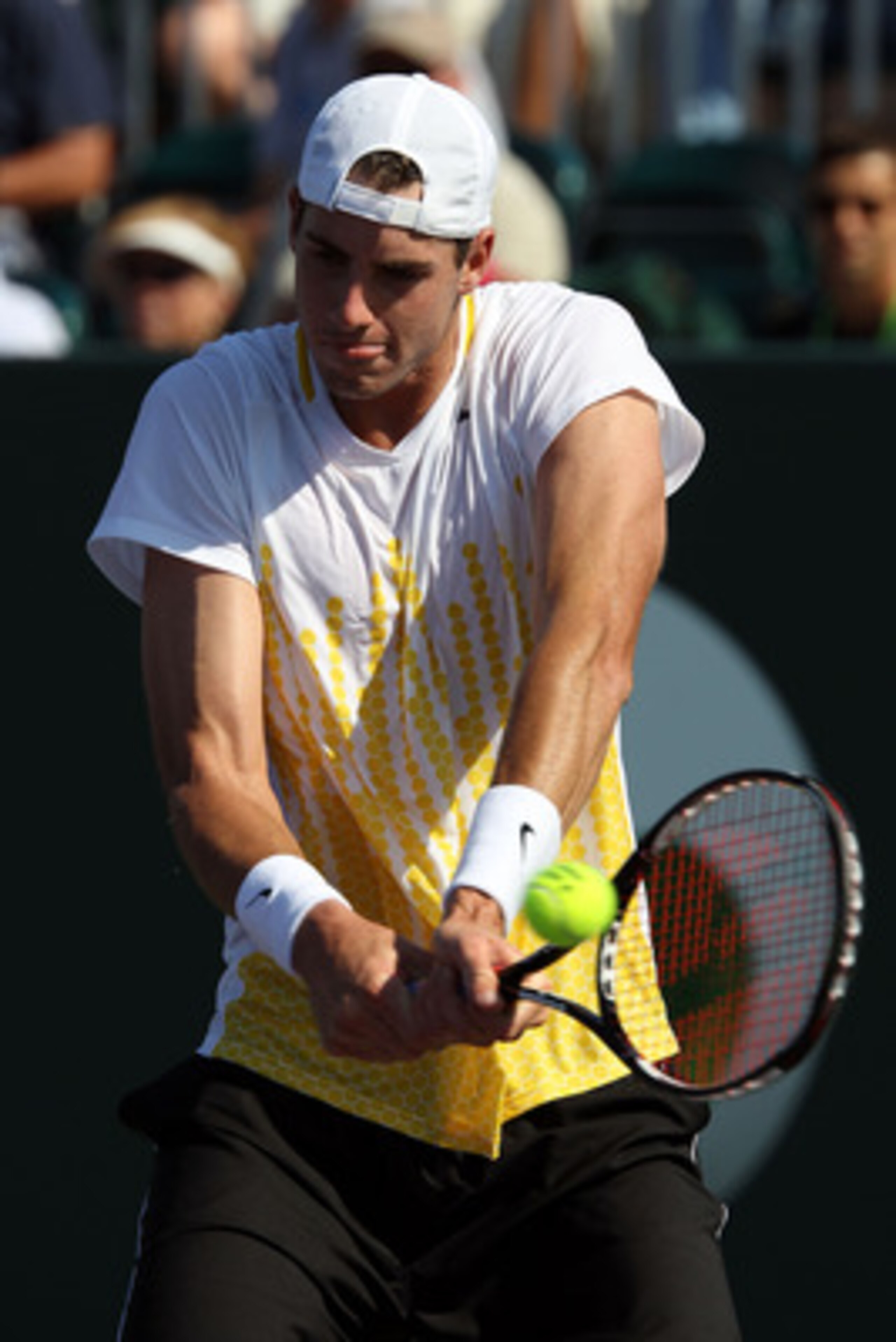 KEY BISCAYNE, FL - MARCH 27:  John Isner gets set to hit a backhand return against Alex Bogomolov Jr. during the Sony Ericsson Open at Crandon Park Tennis Center on March 27, 2011 in Key Biscayne, Florida.  (Photo by Clive Brunskill/Getty Images)